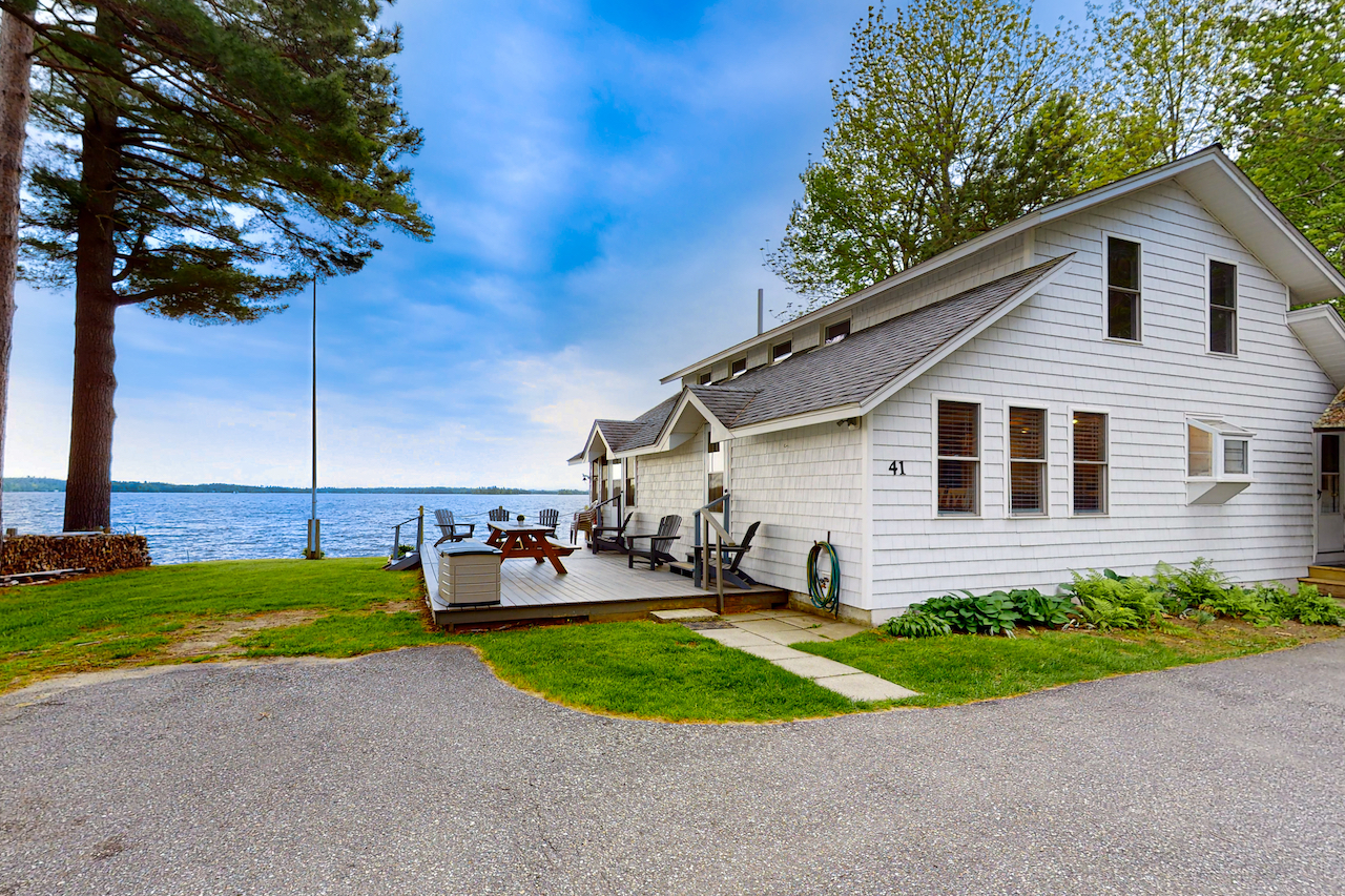 White lake house on the water in Winthrop, ME.