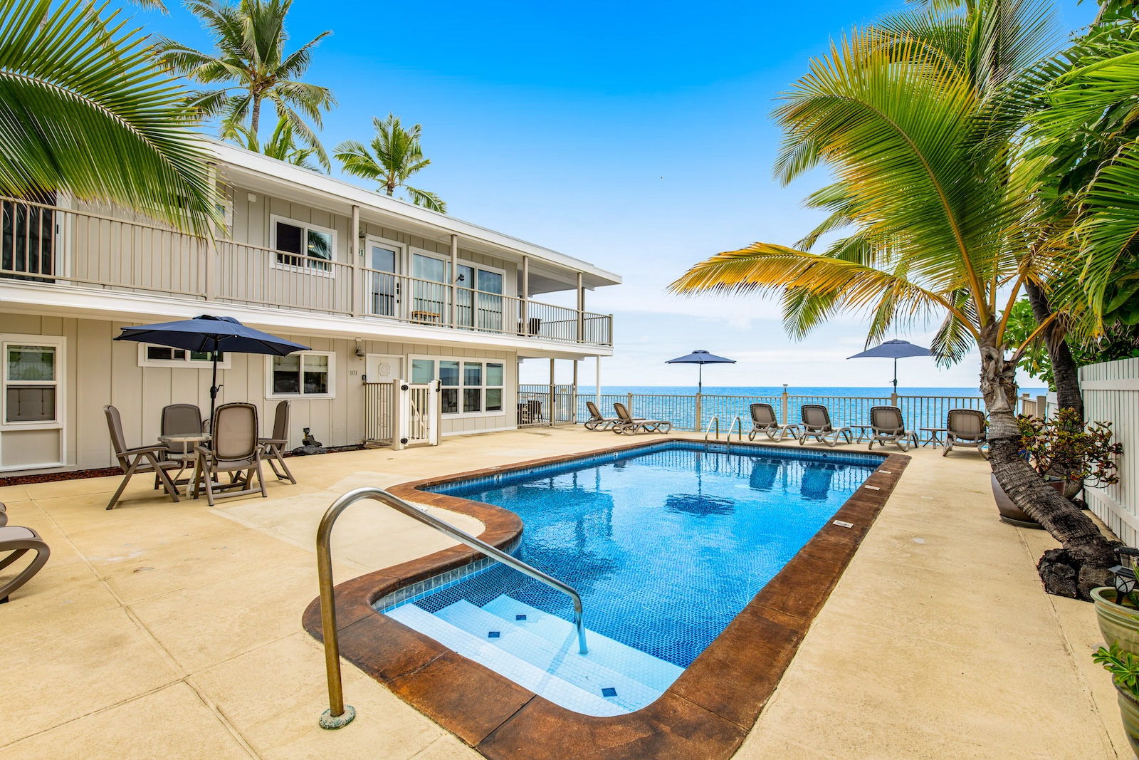 The pool area overlooking the ocean at a Kailua-Kona rental.