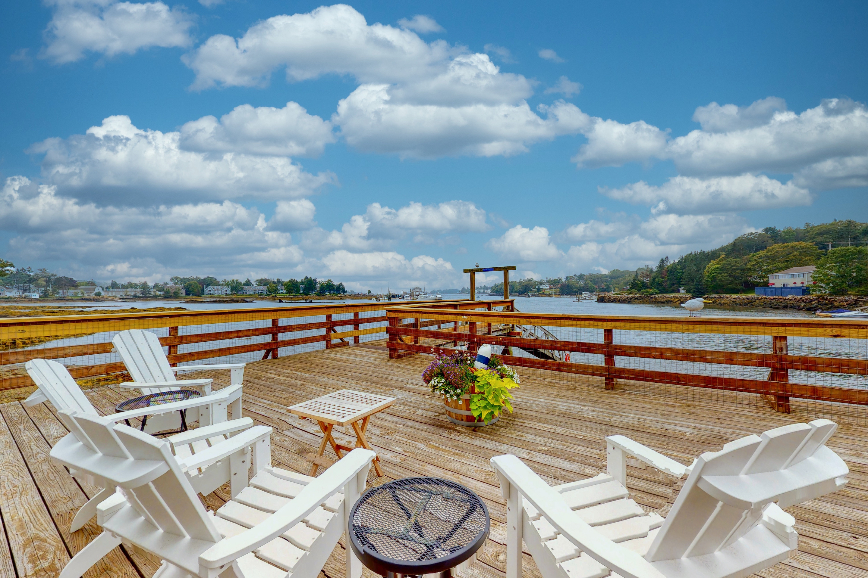 Chairs sit on deck of Boothbay Harbor home with beach access