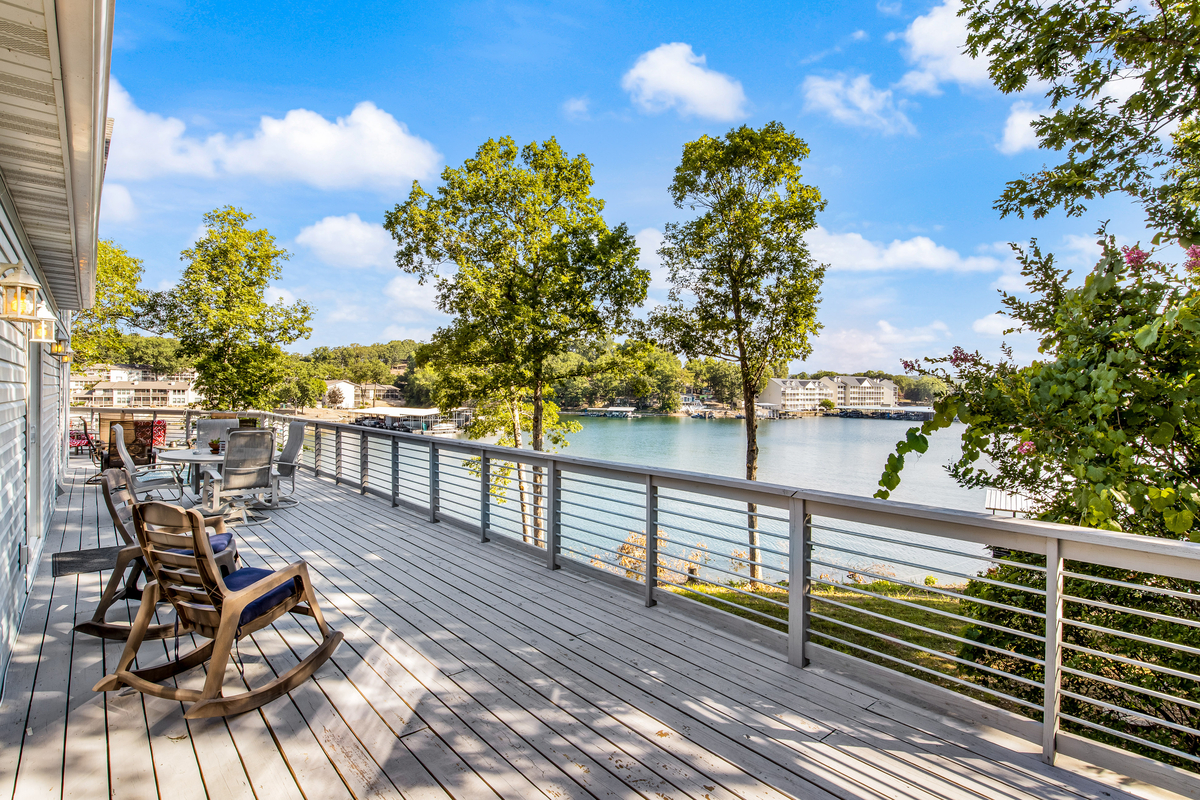 Back porch of a vacation rental with a view of a lake