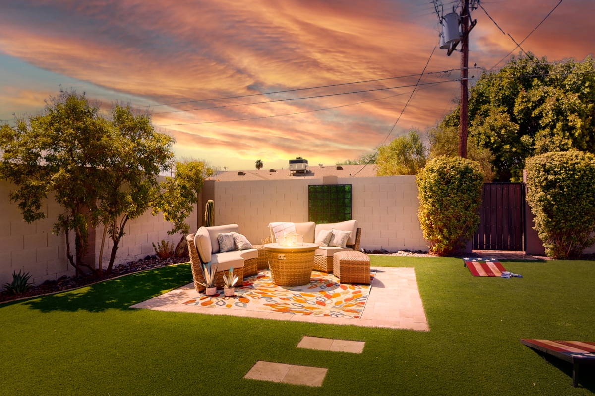 backyard with a cozy outdoor lawn during sunset