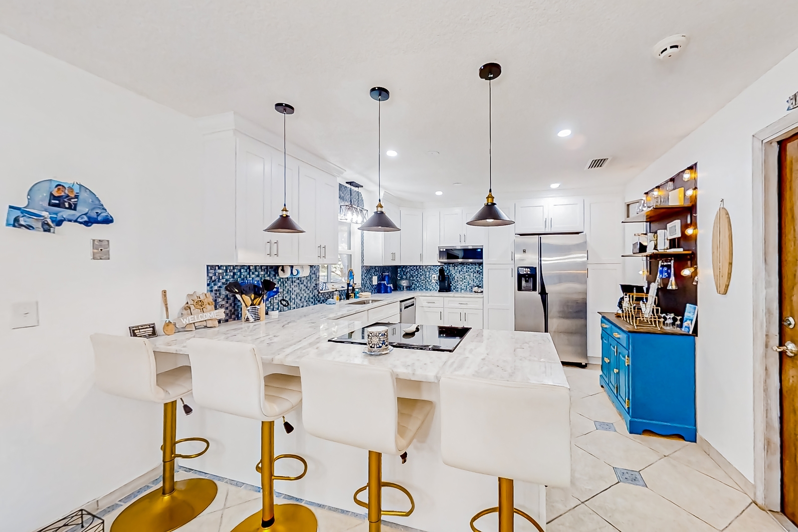 inside a vacation rental kitchen with a bar style counter top
