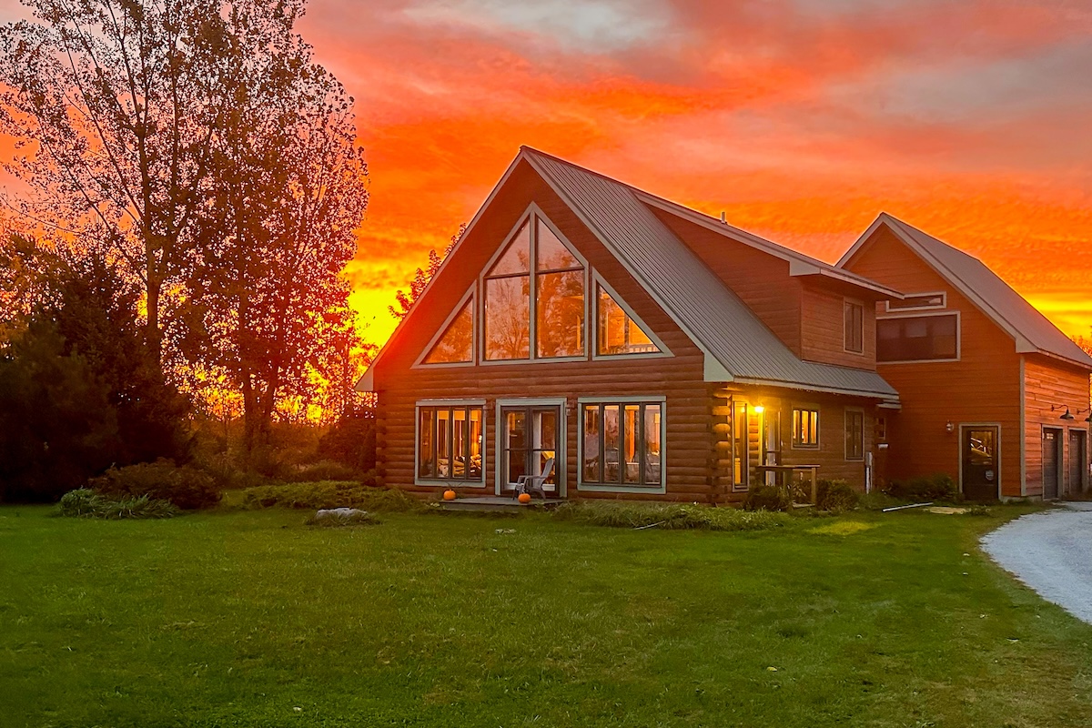 Exterior of a vacation rental in Isle La Motte, VT while a sunset is happening.