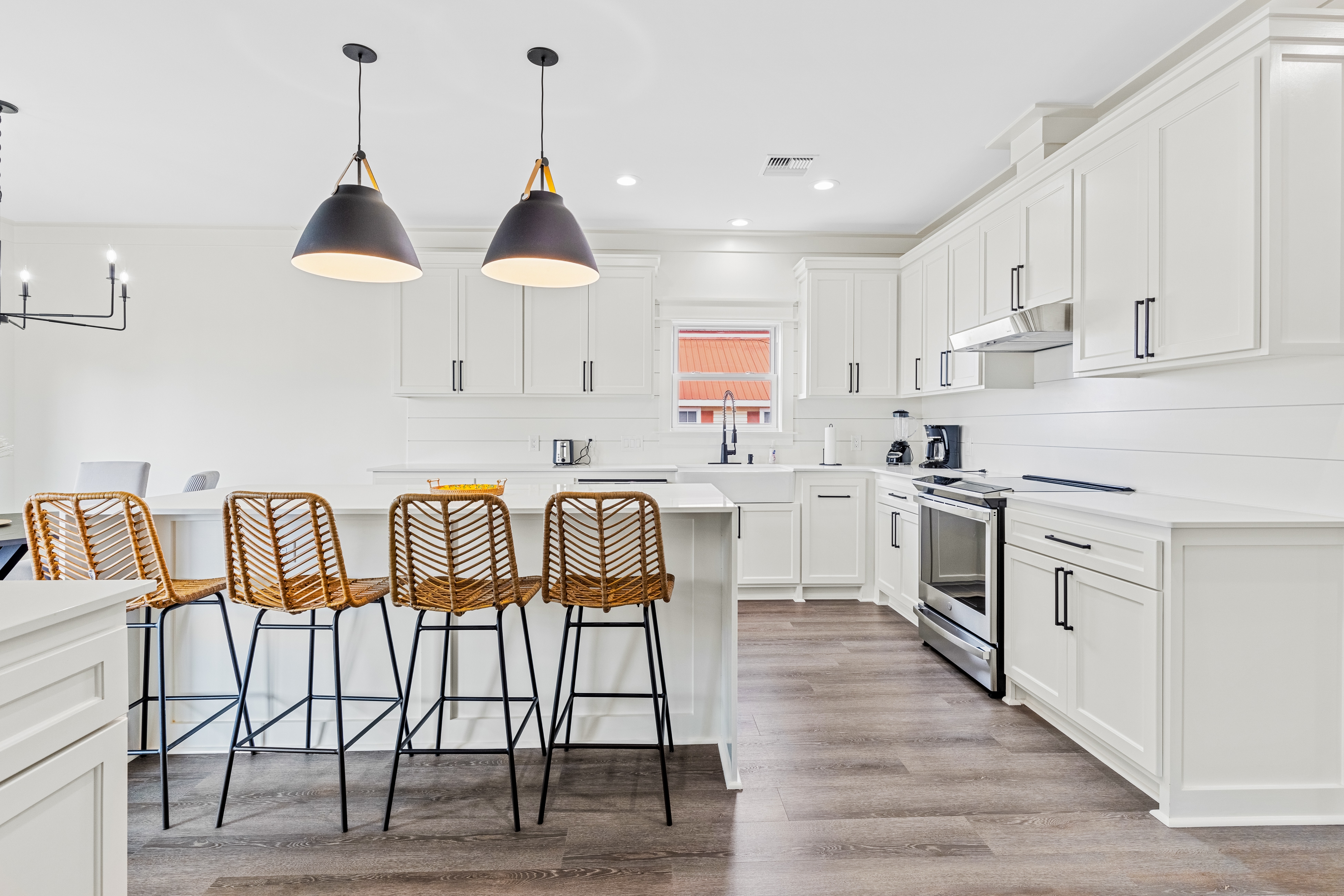 clean, white, modern kitchen with four chairs around the island