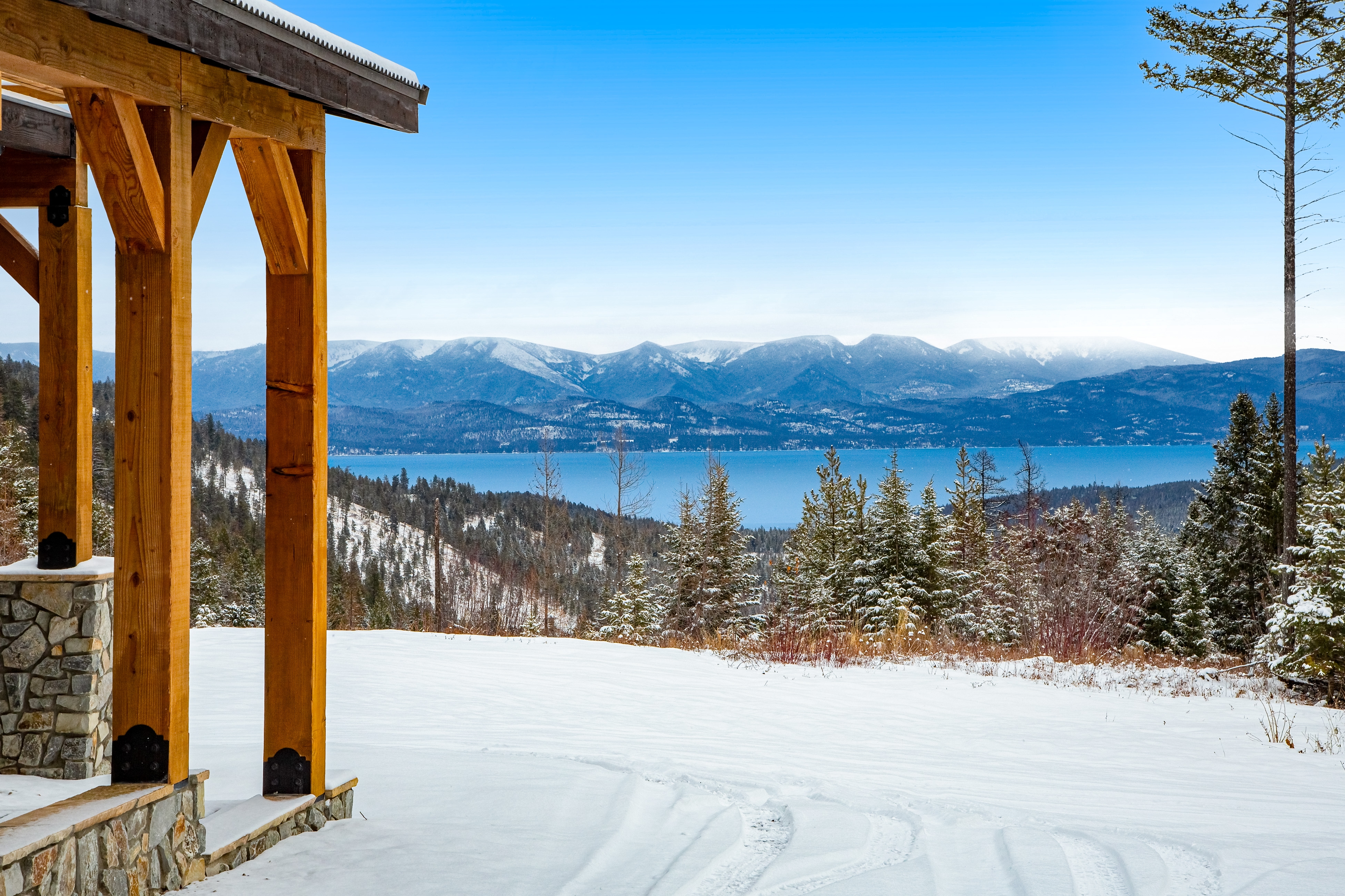 cabin overlooking flathead lake in a snowy winter landscape