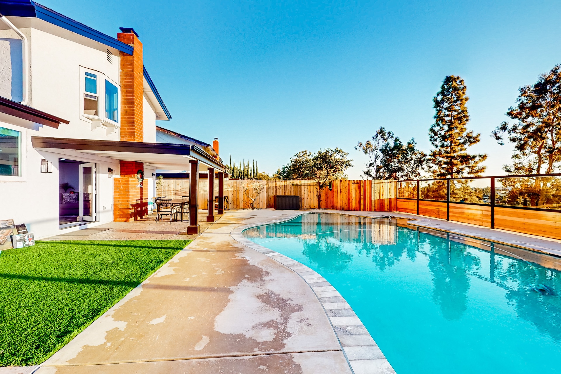 The pool area and backyard area of a vacation rental in San Diego.