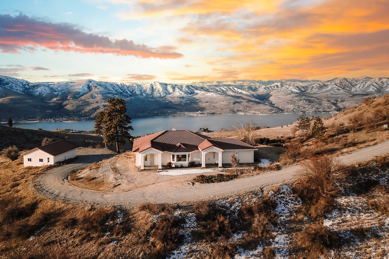Drone shot of the vacation rental overlooking Lake Chelan, WA during sunsset.