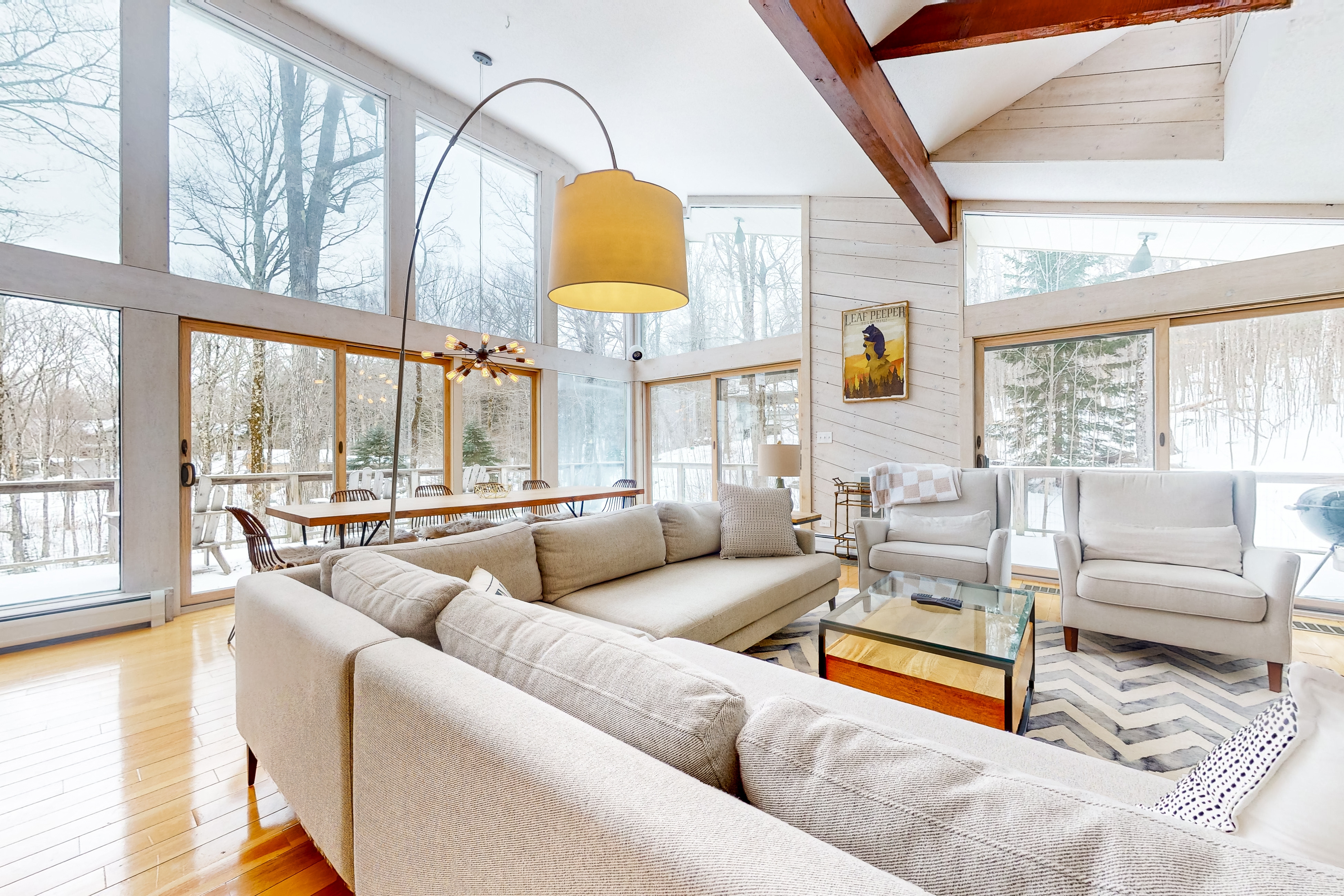 living area of modern ski home with large windows and a cozy couch