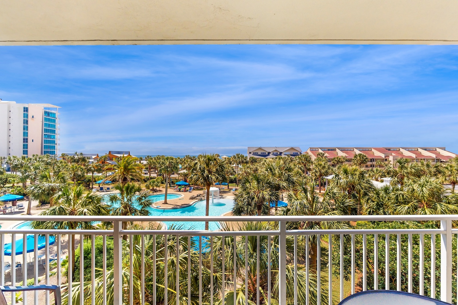 The view from the patio of a Destin, Florida resort condo rental with a pool.