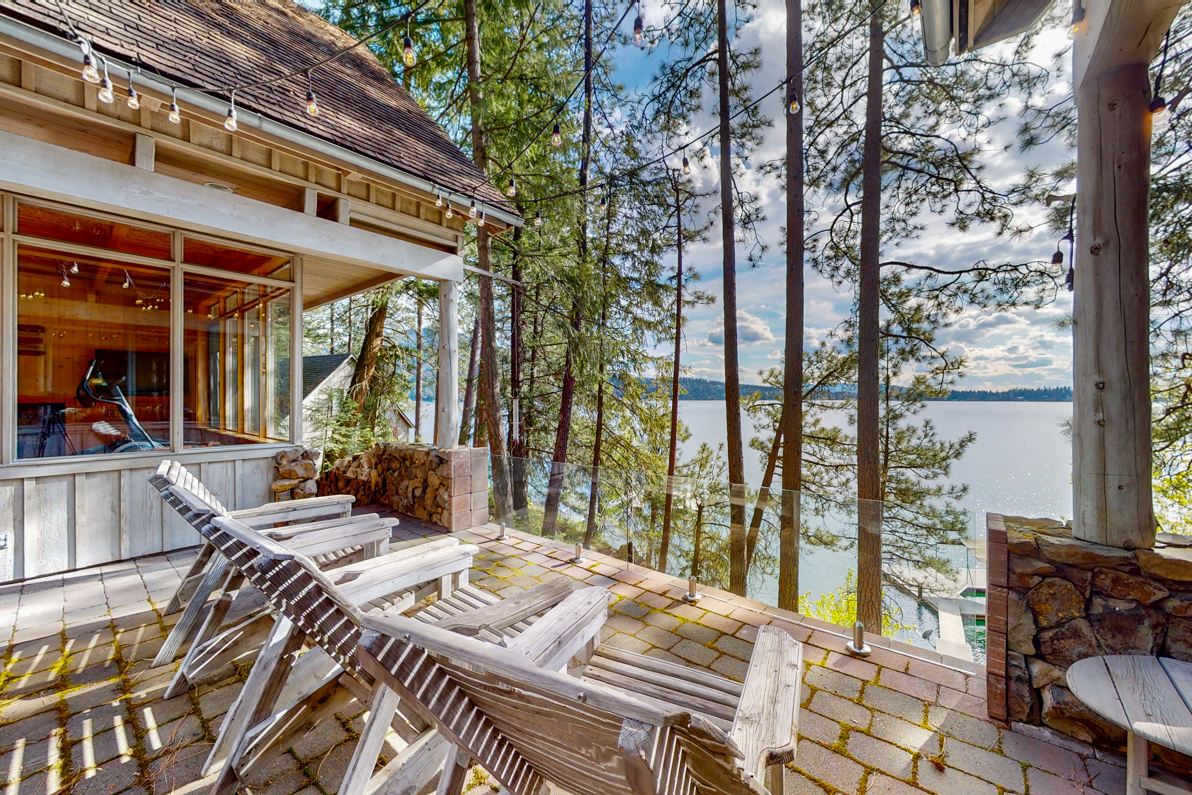 Chairs on a patio of a vacation home overlooking the lake coeur d'alene on a partly sunny but beautiful day