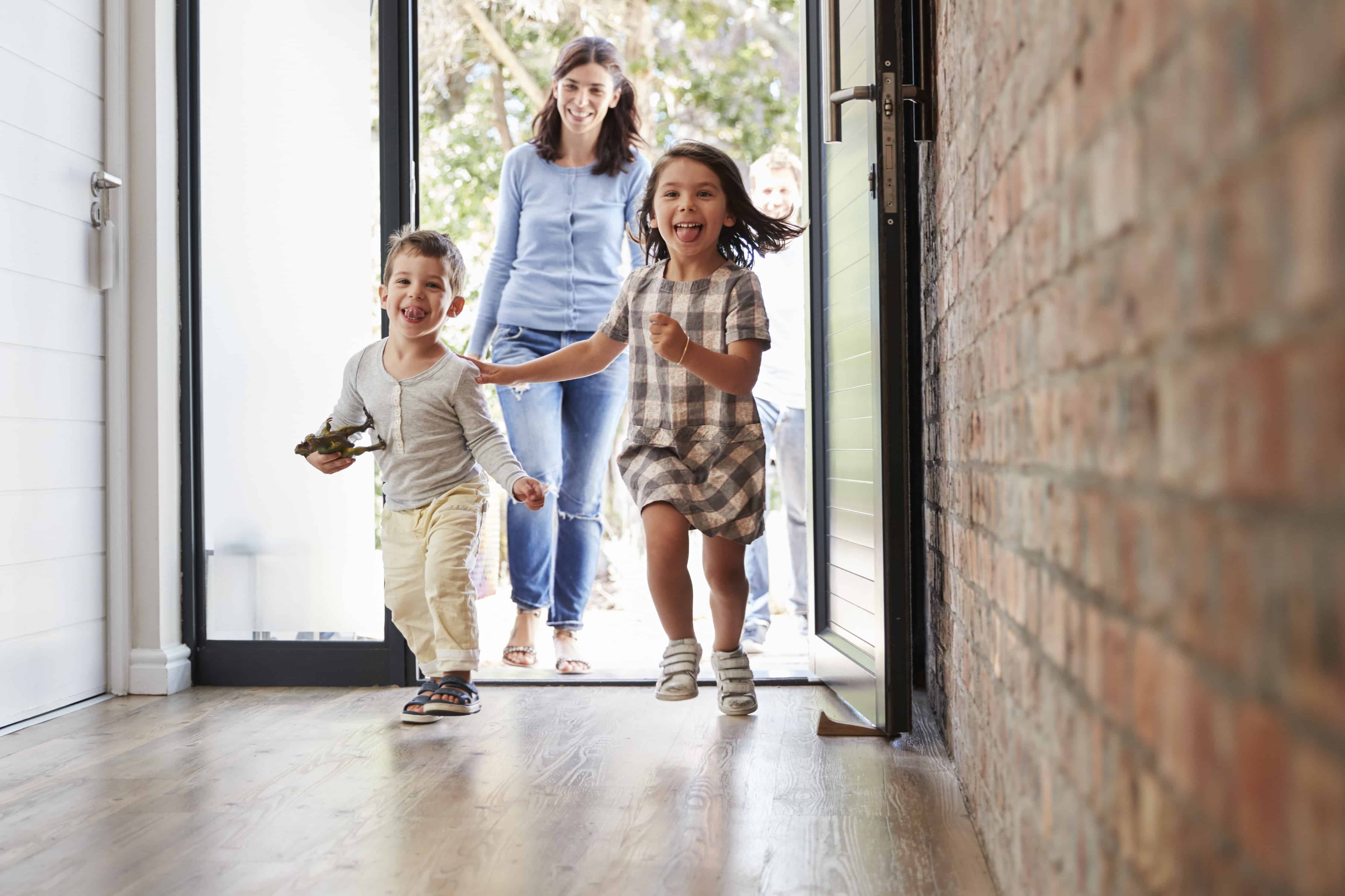 kids running through the front door of their family's vacation home.