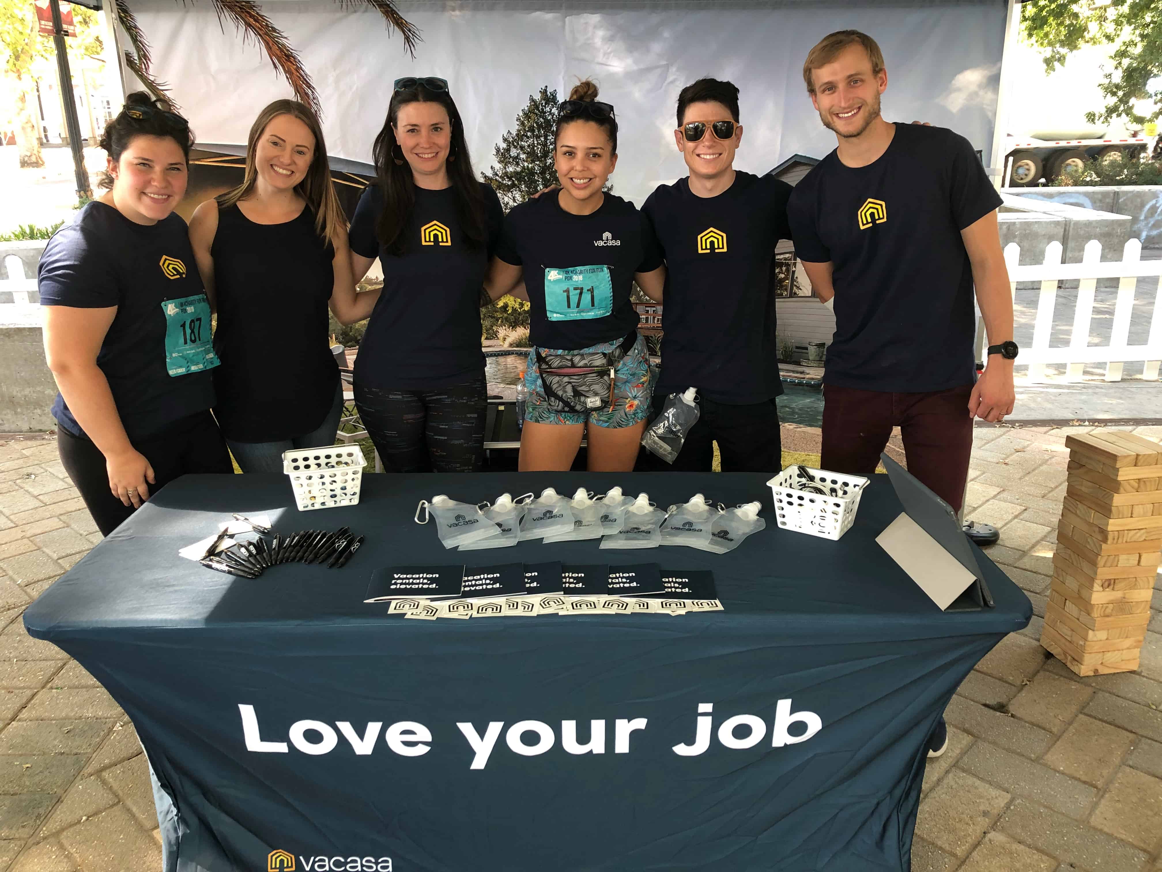 the Vacasa team smiling at an event