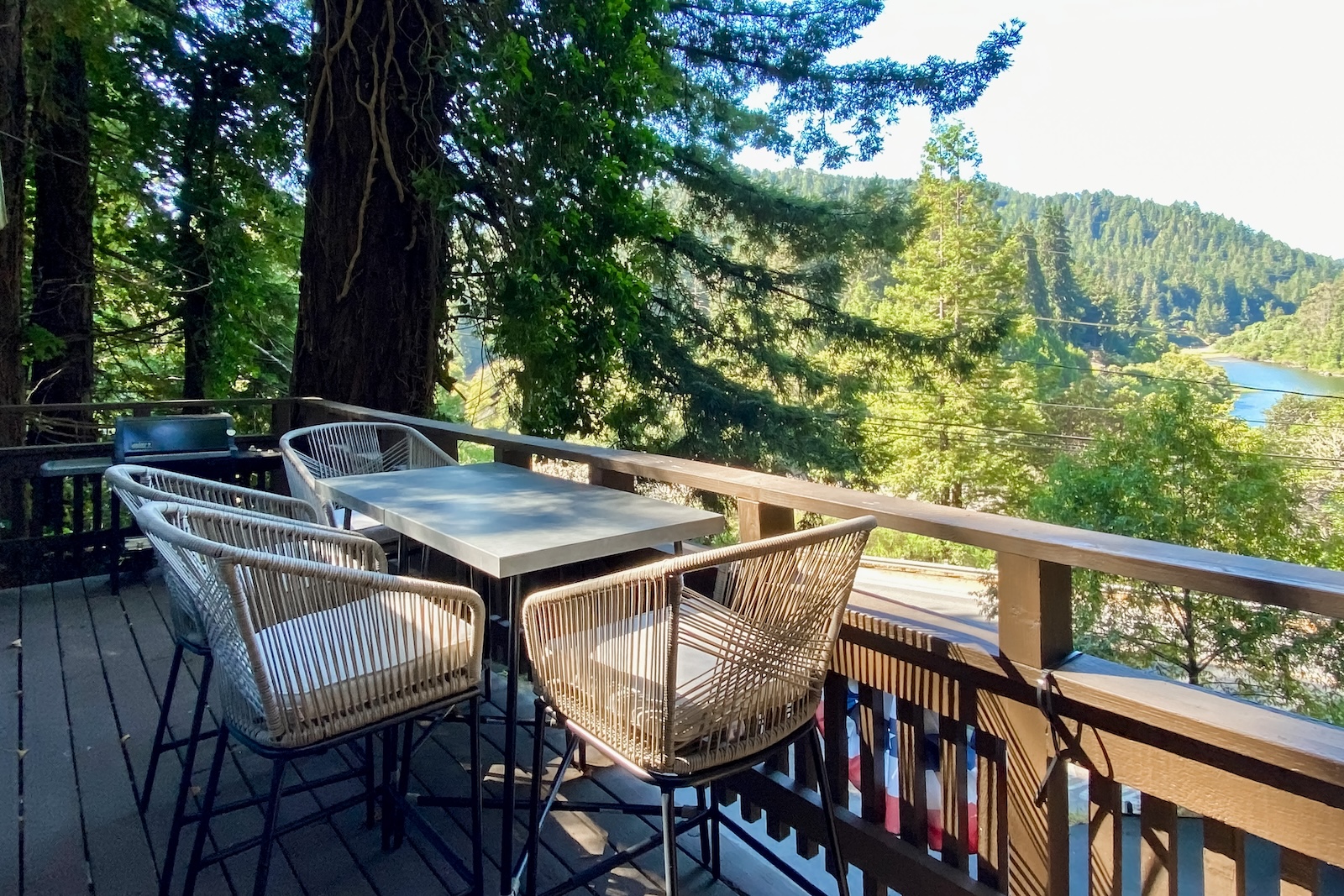 The back patio overlooking the river at a Monte Rio rental.