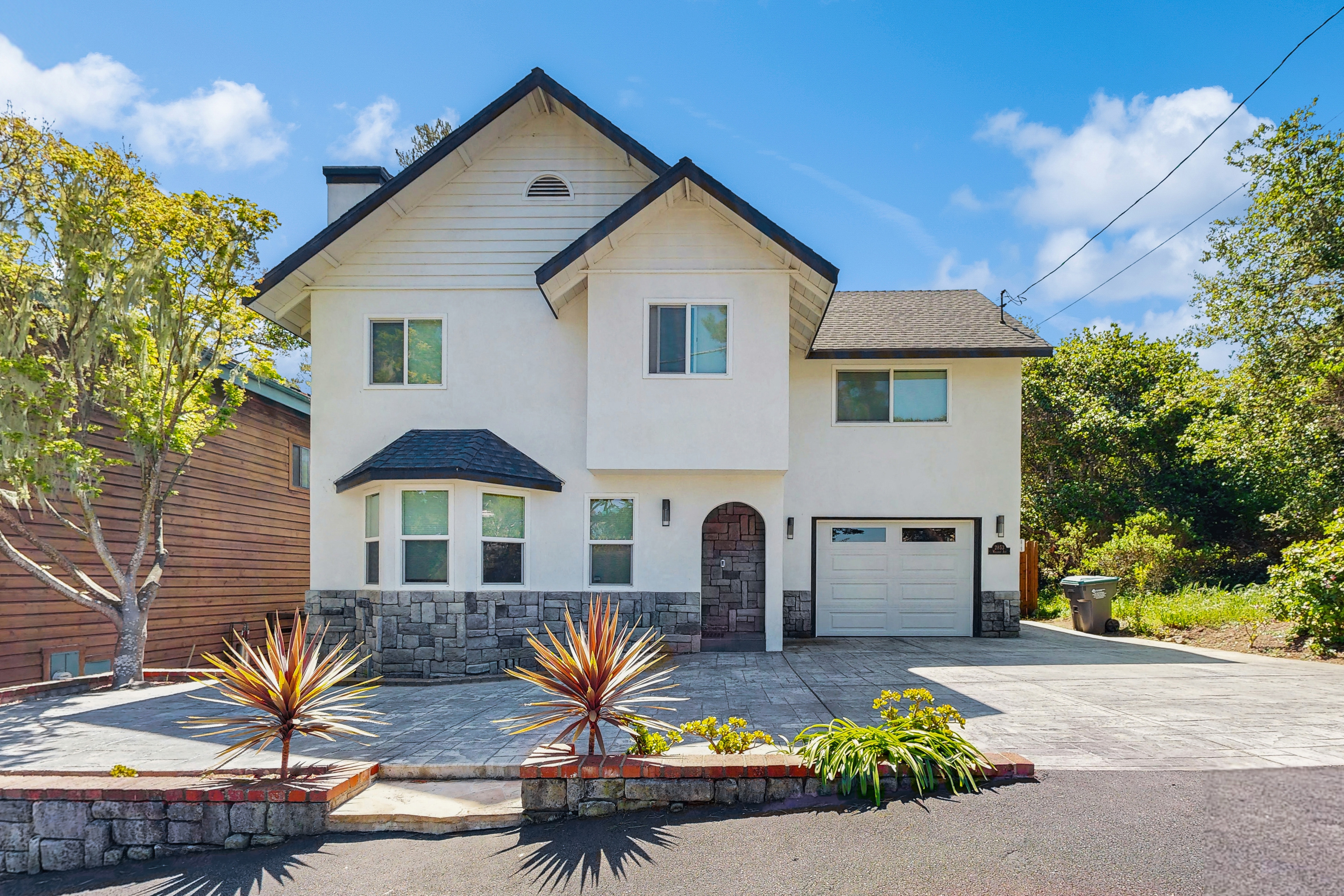 vacation home in cambria, california with small palm tree out front