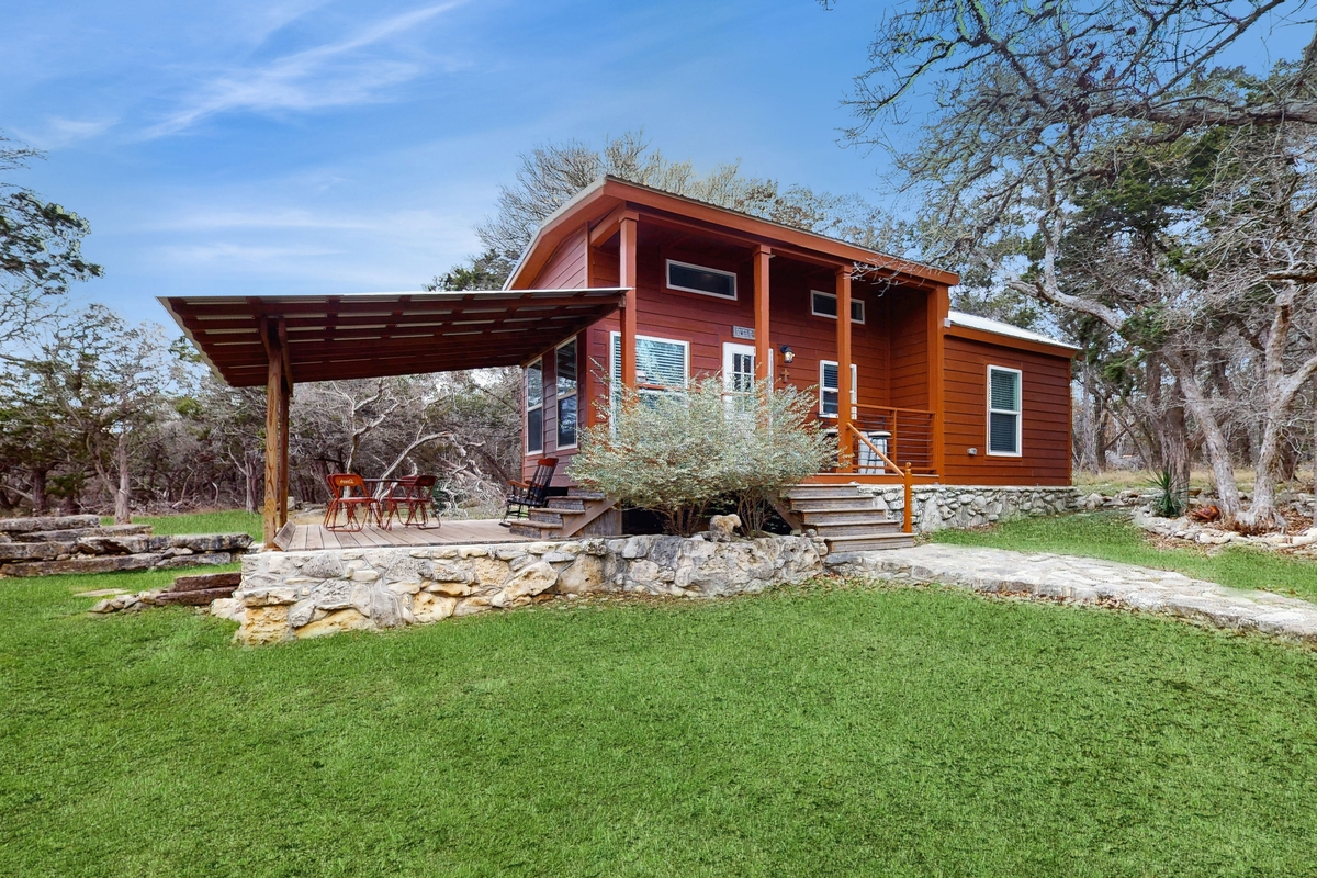 red cottage with an undercover side deck in Wimberley, Texas