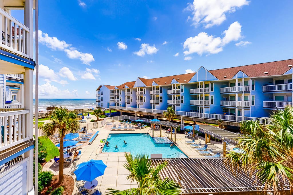A resort with an outdoor pool near the ocean shore in Gulf Coast, TX.
