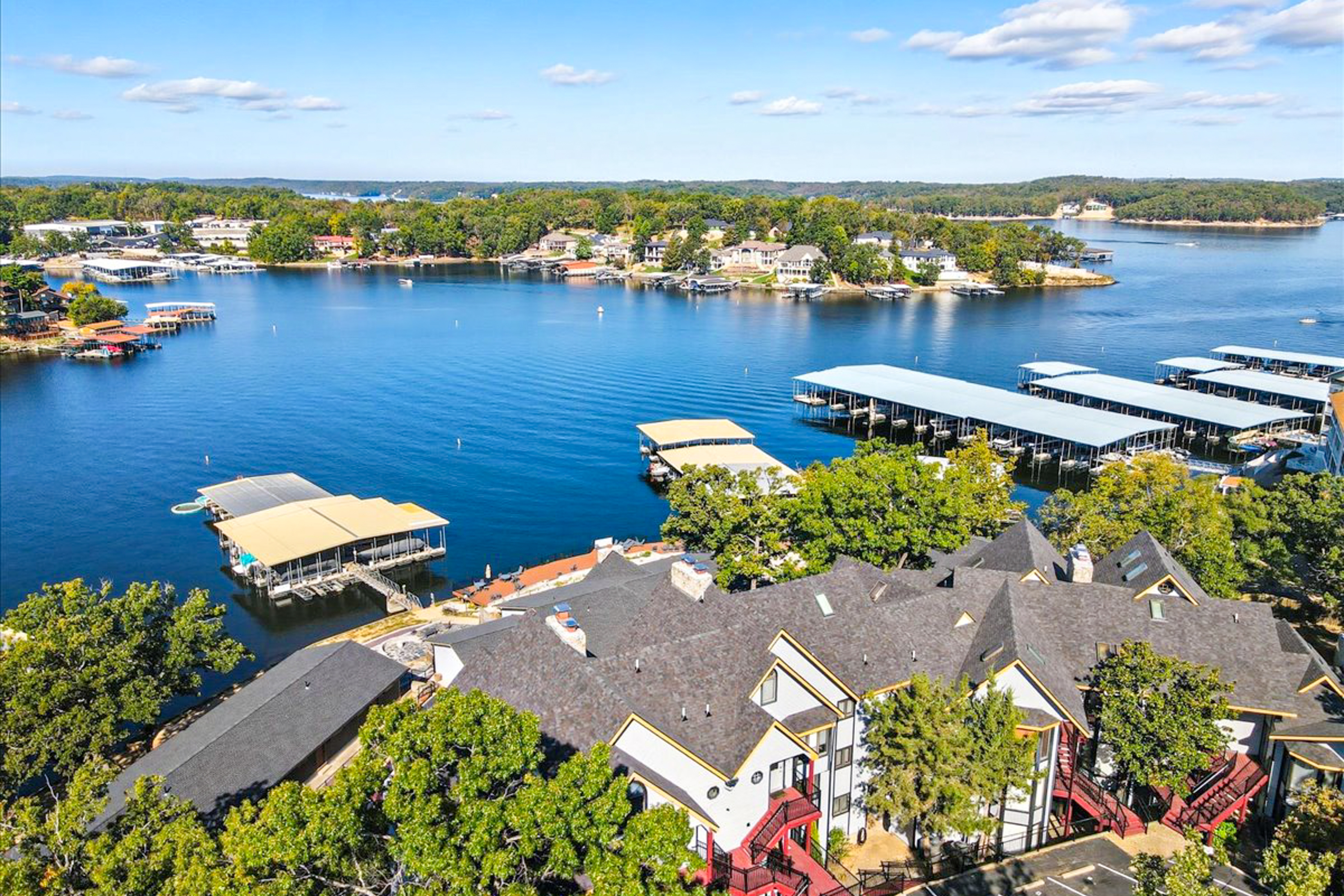 private docks and lake homes pepper lake of the ozarks in aerial shot on a sunny day