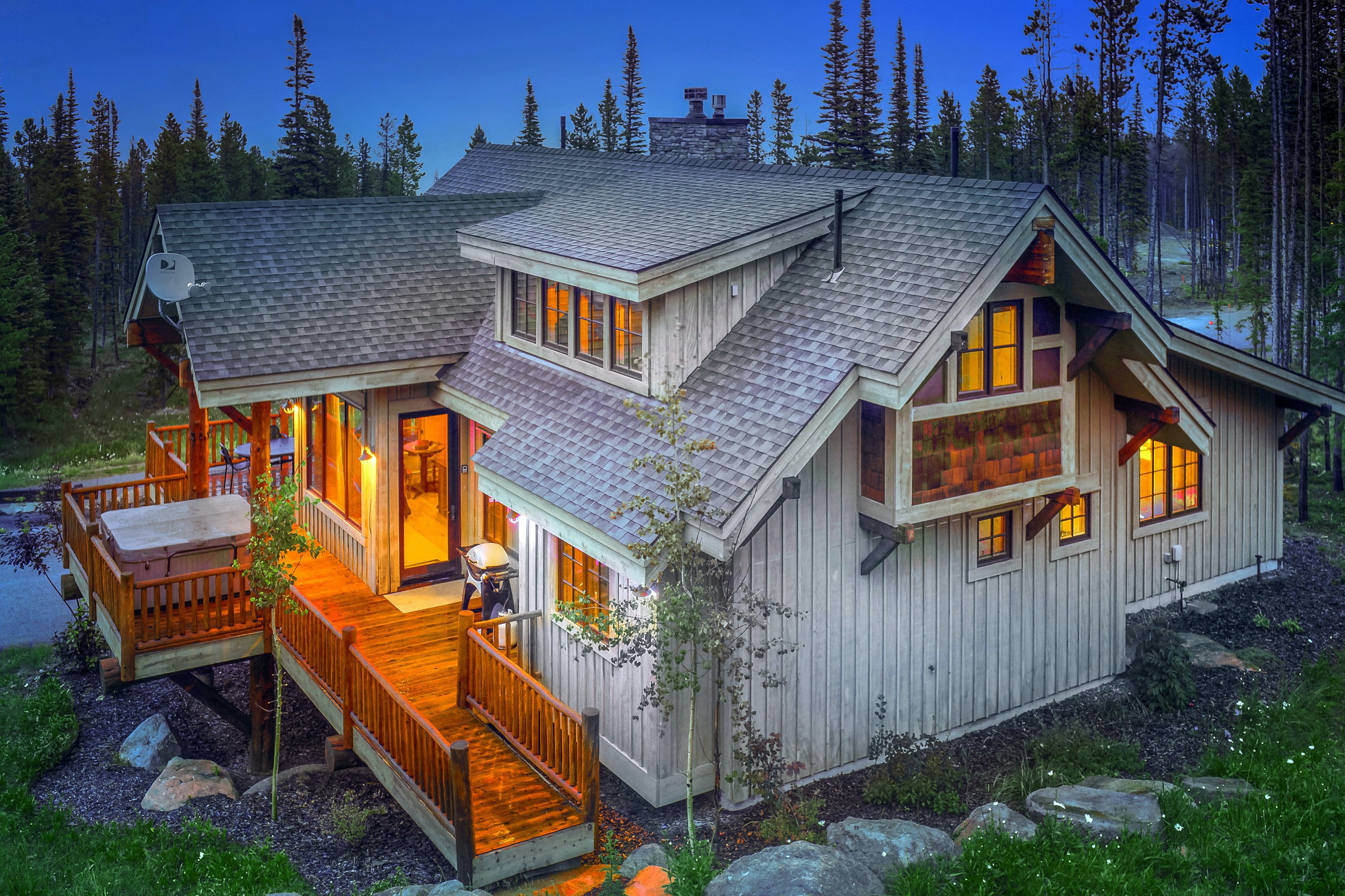 large cabin rental in Big Sky, MT lit up at night