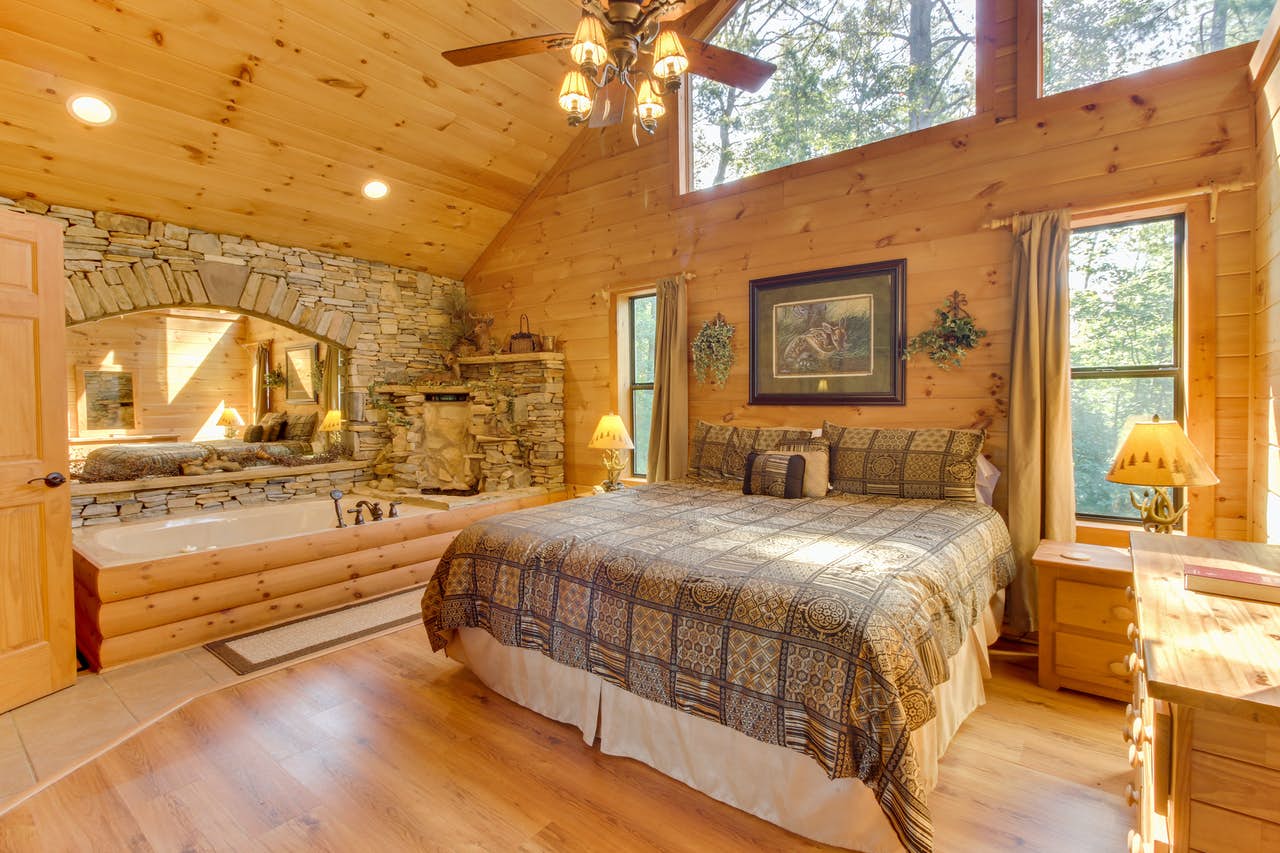 master bedroom with stone-framed jacuzzi complete with waterfall feature