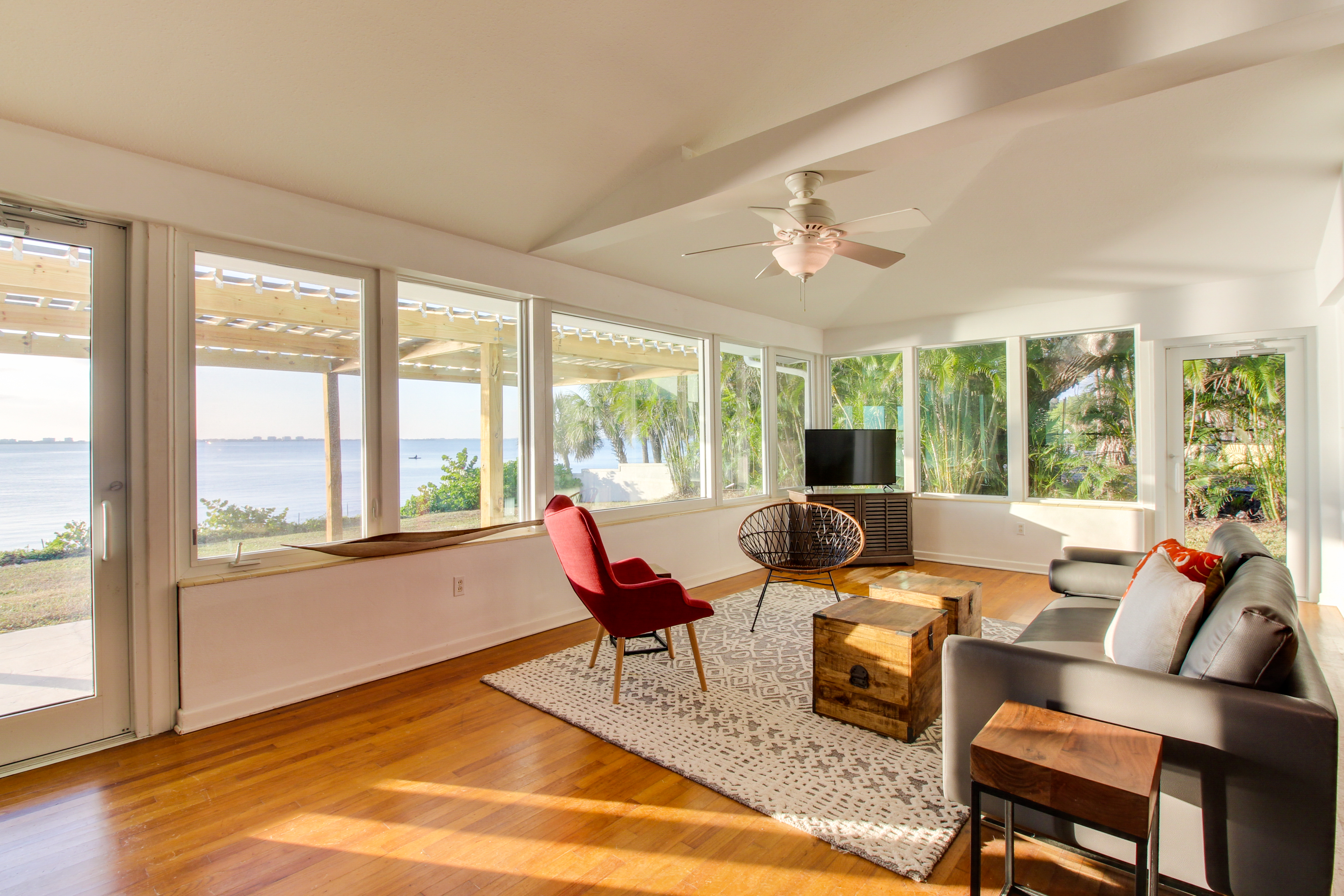 beach facing windows surround the sitting area of a Sarasota, FL vacation home