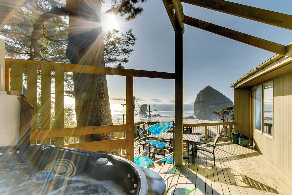 The view of Haystack Rock with a hot tub at a vacation rental in Cannon Beach.