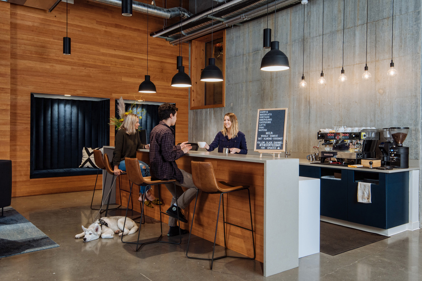 People ordering coffee drinks from a barista at the Vacasa in-house coffee bar