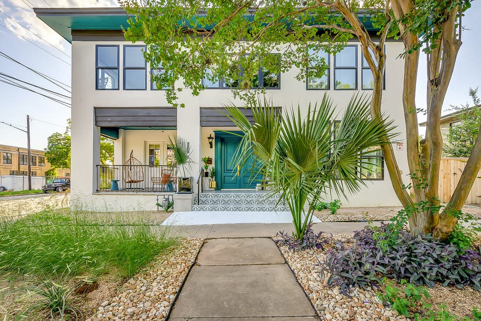 vacation home with tiled steps and palm trees in front