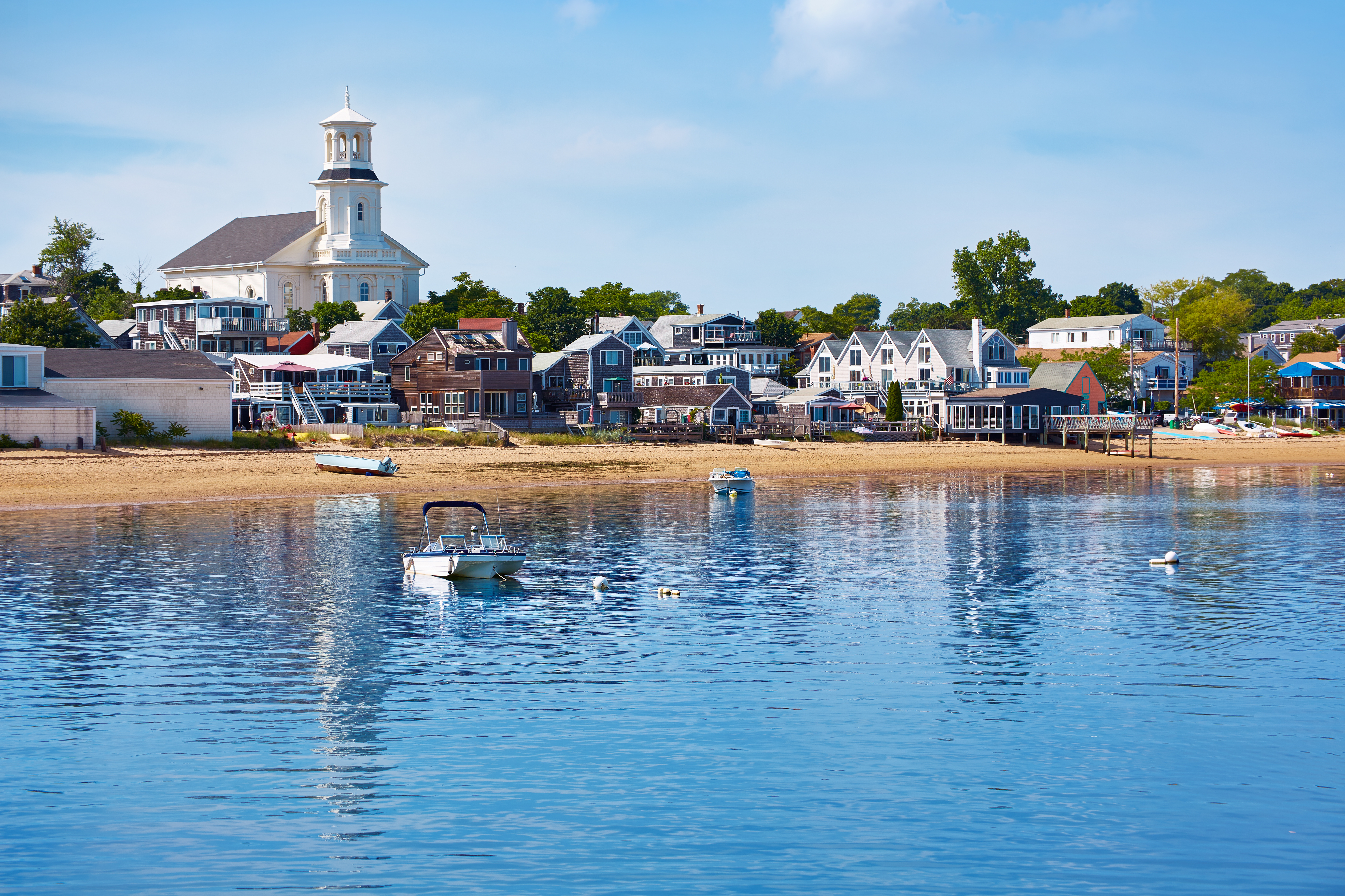 View of Cape Cod coastline with waterfront houses and beachgoers
