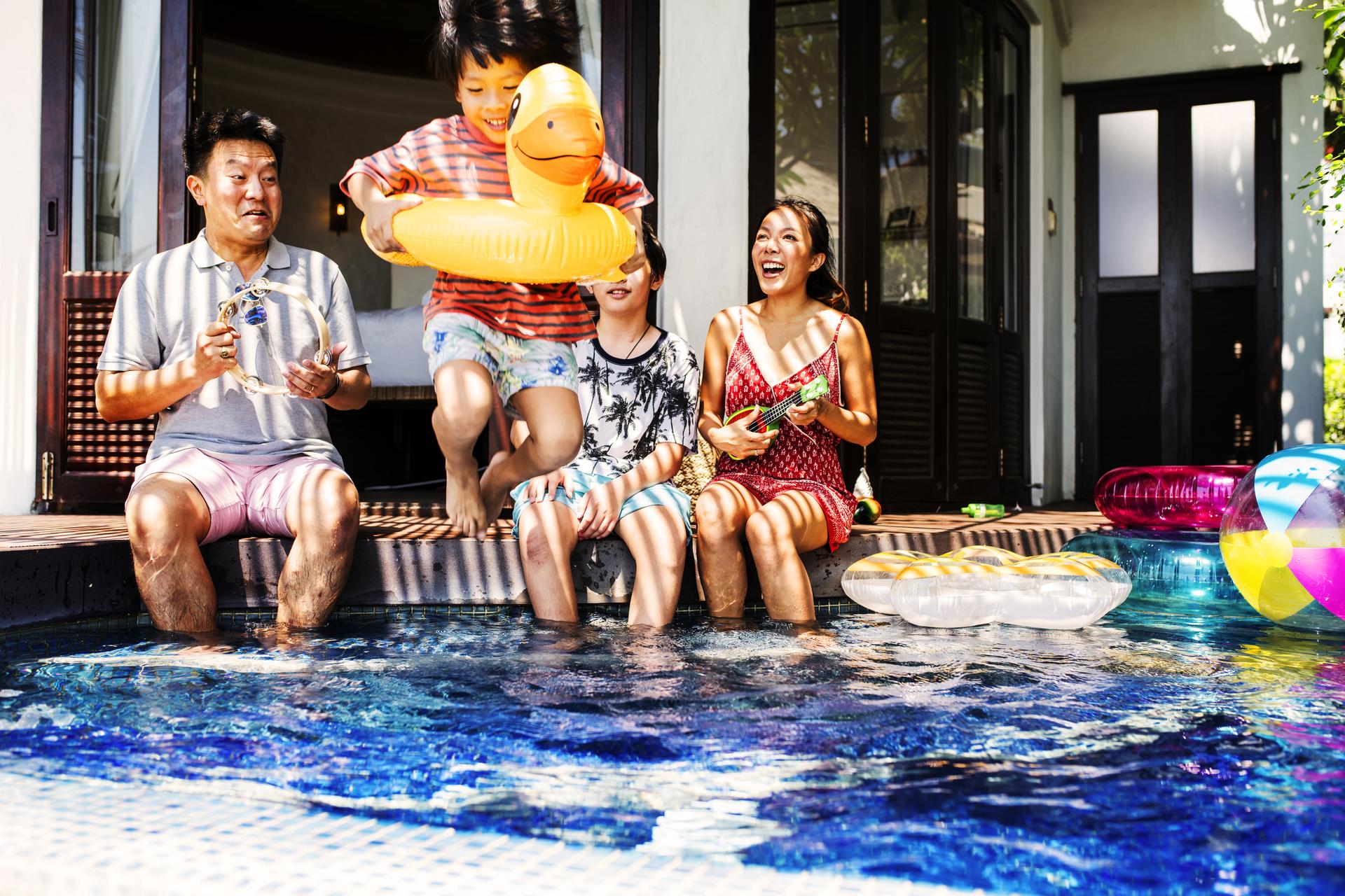 Family playing in a pool.