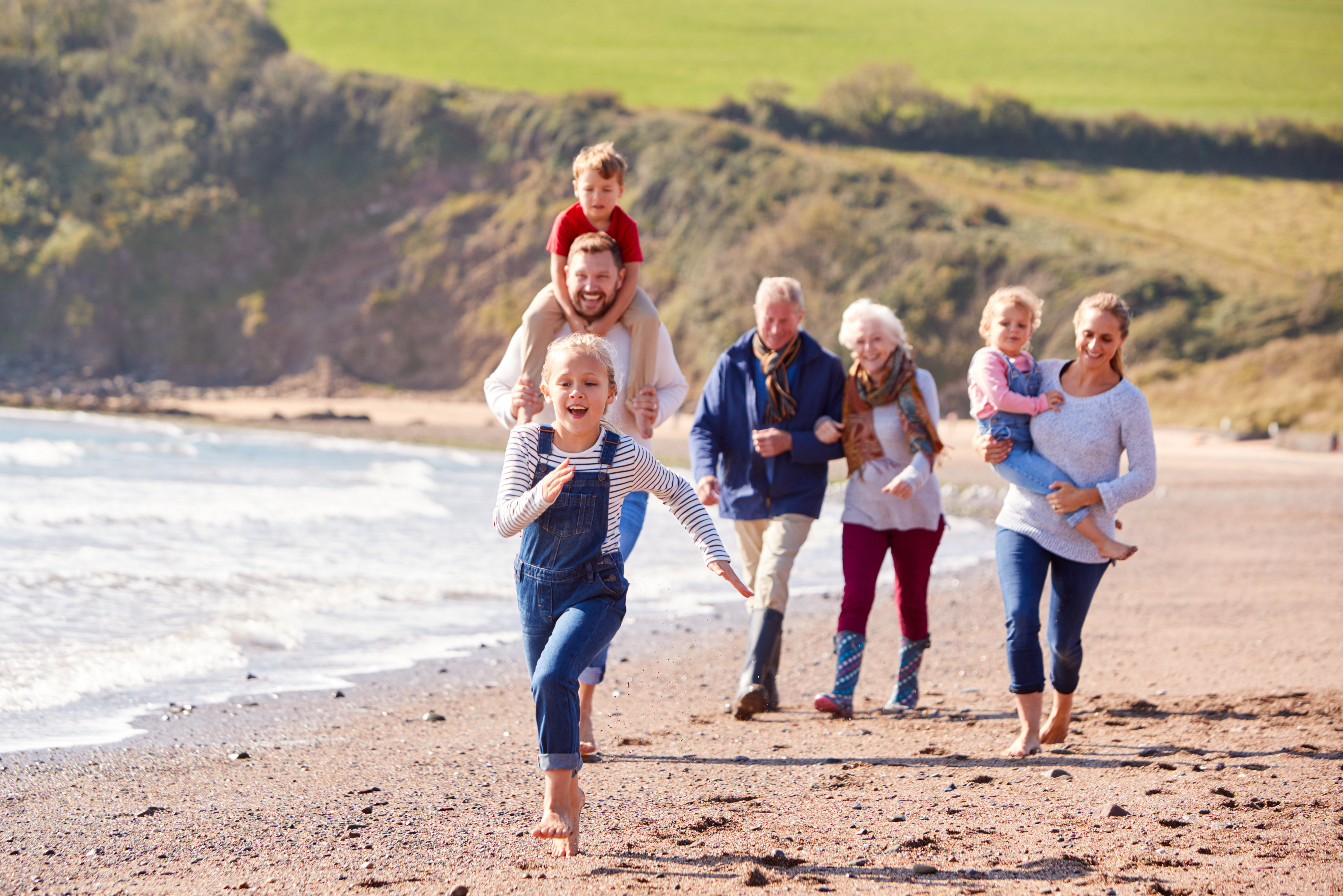 extended family enjoys a day at the beach