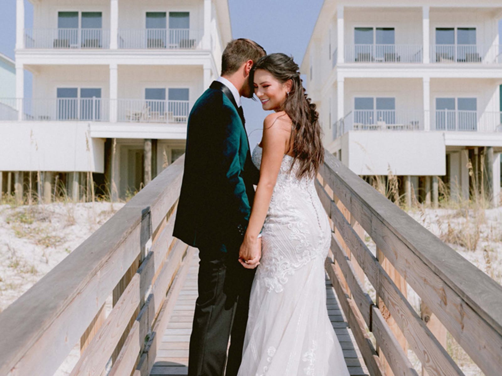 Wedding photo taken on the boardwalk to the beach at a vacation rental