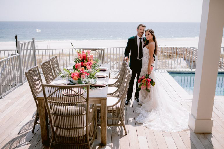 Newlyweds on a balcony at a vacation rental in Alabama.