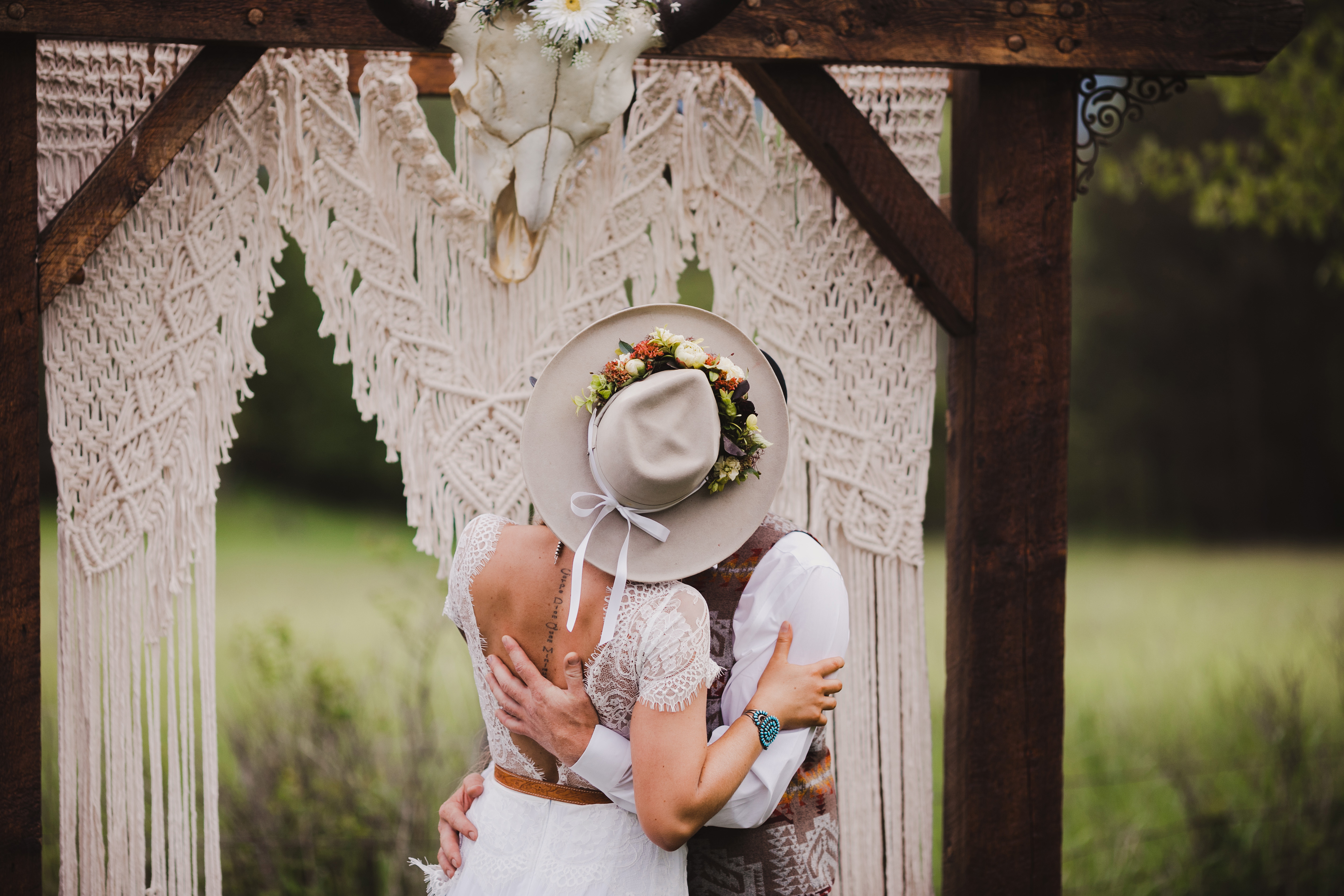 Couple kissing by an arbor