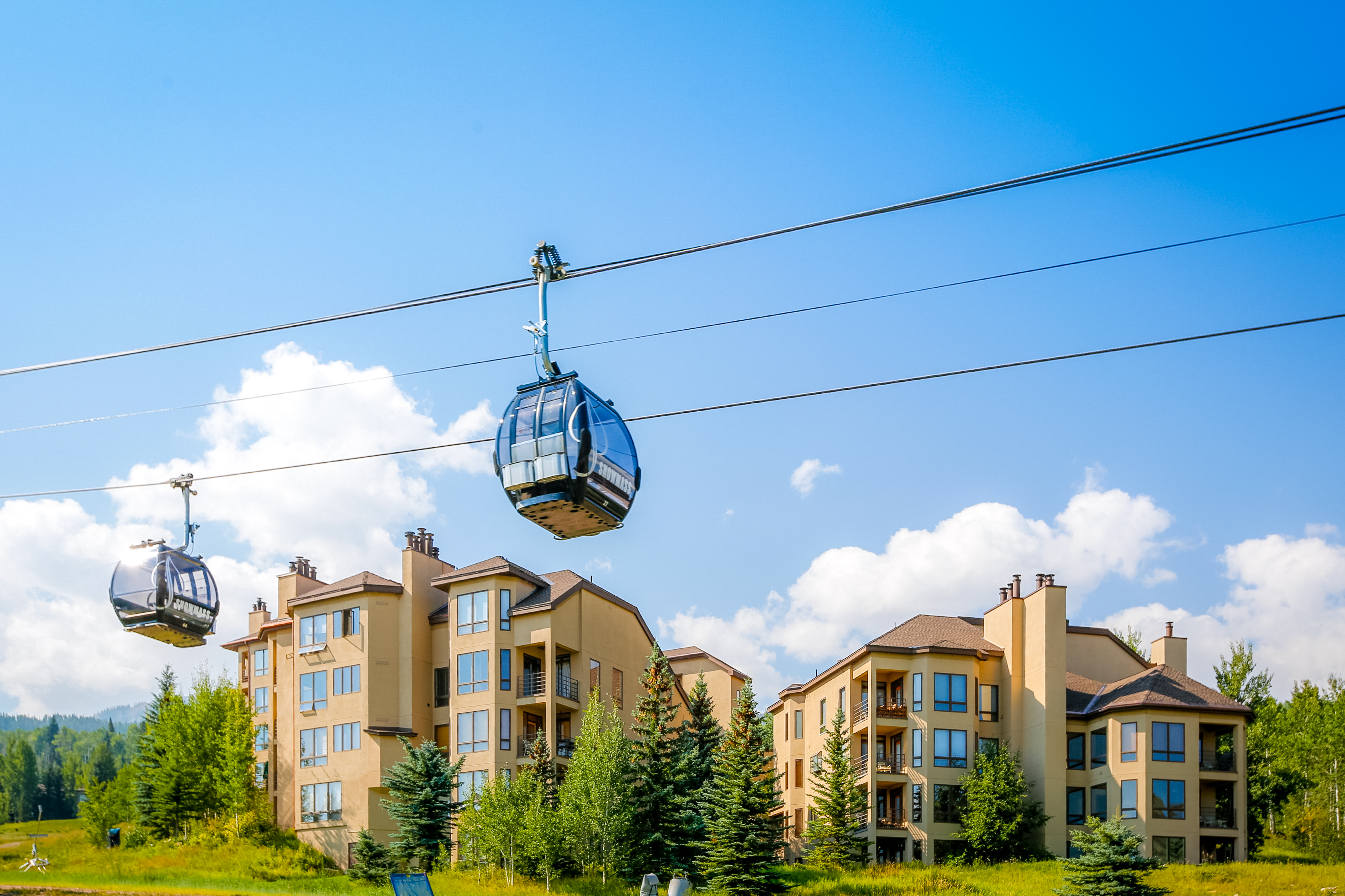 Gondola lift passing by a condominium complex in Aspen Snowmass, CO