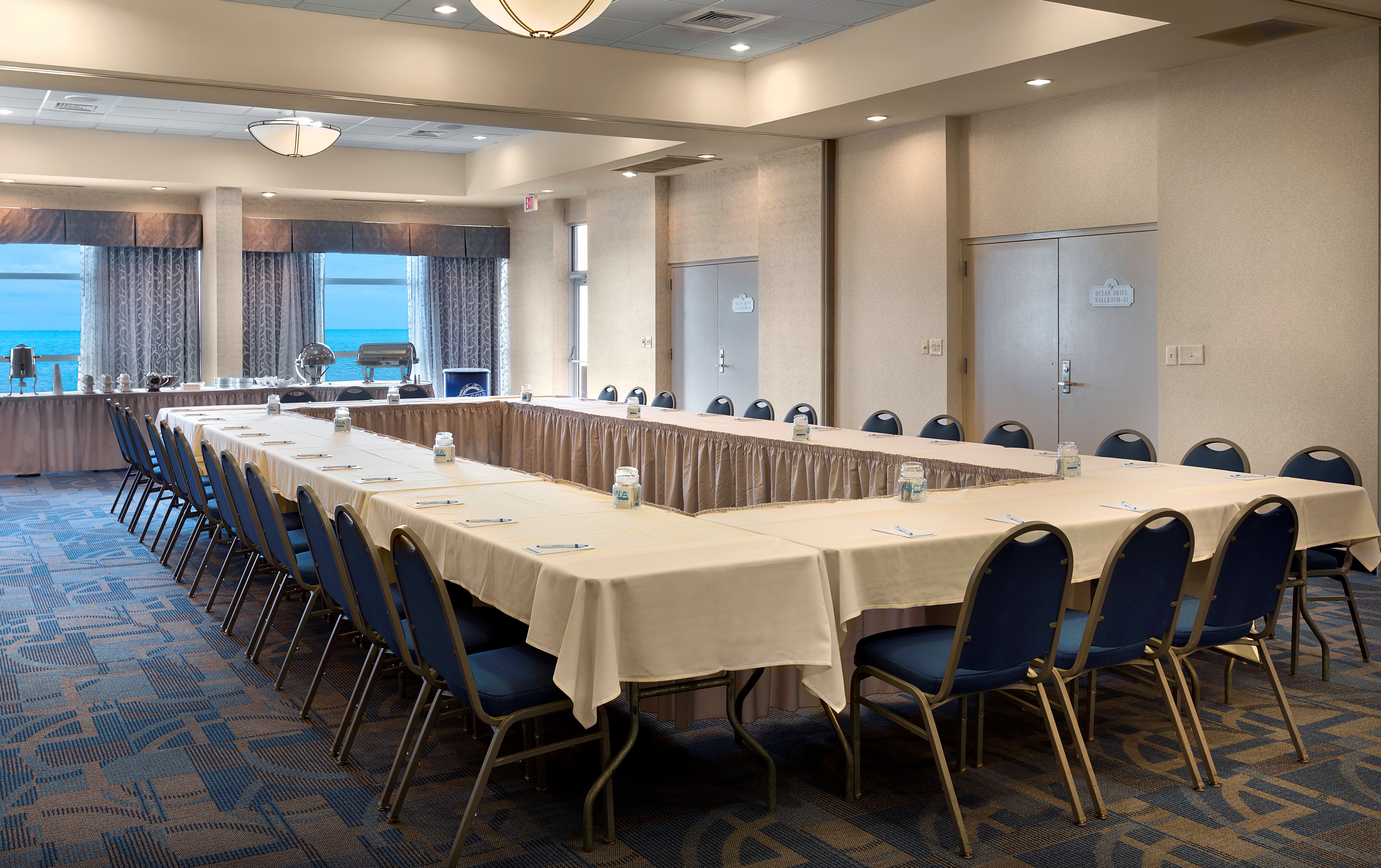 Conference room with tables and chairs at Bay Watch Resort.