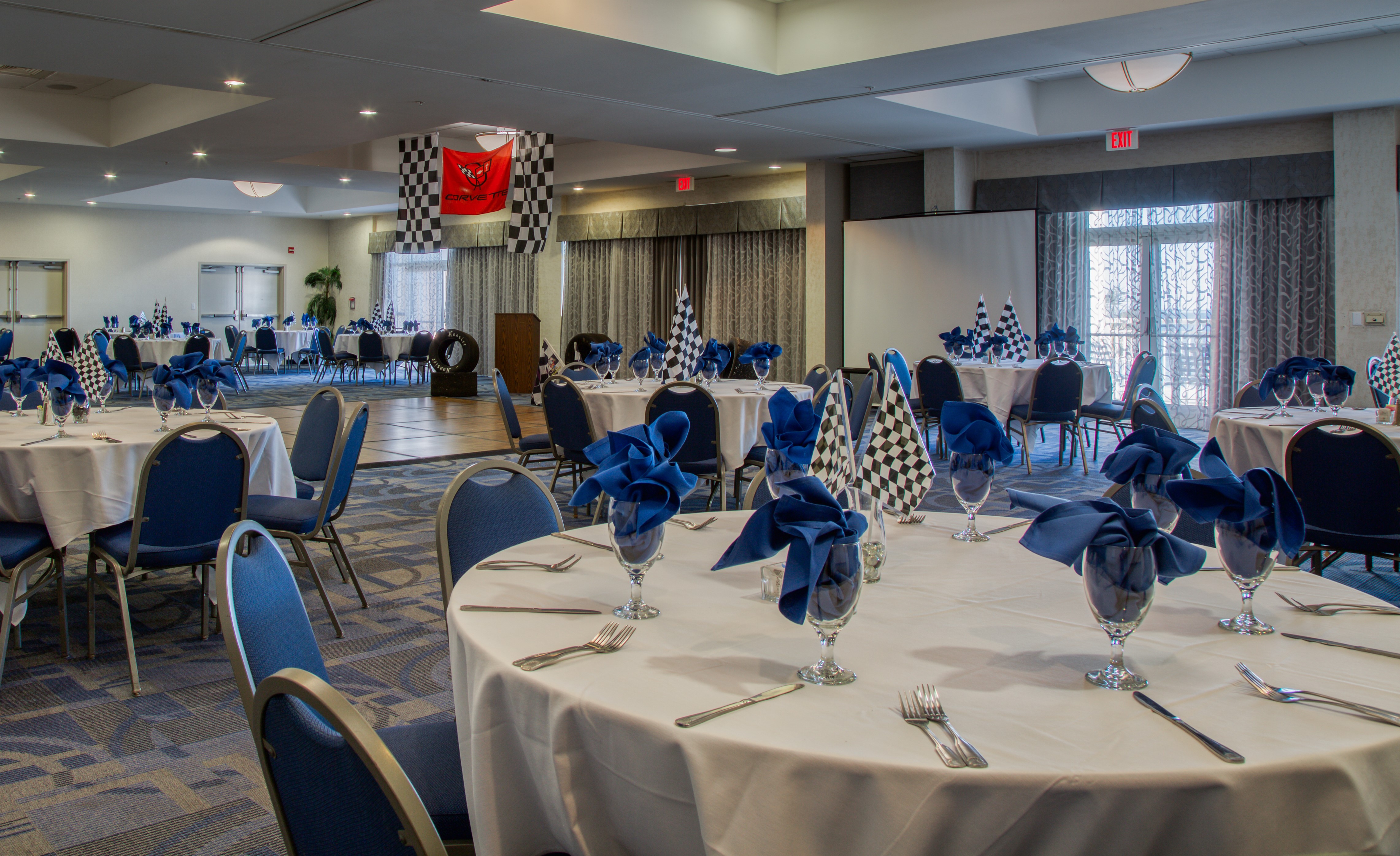 Conference room with checkerboard flag themed decor for an event at Bay Watch Resort.
