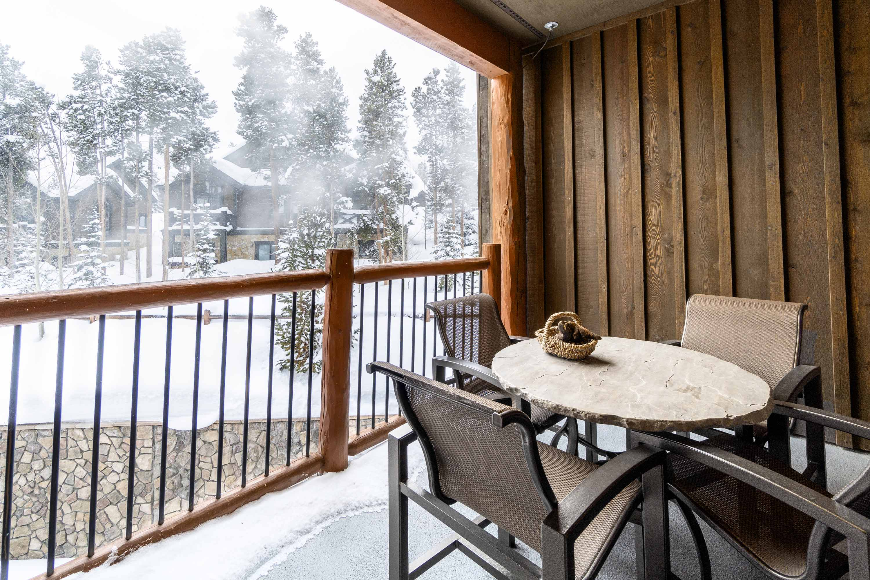 Outdoor balcony looking out towards a snow covered resort and lodge in Breckenridge, CO.