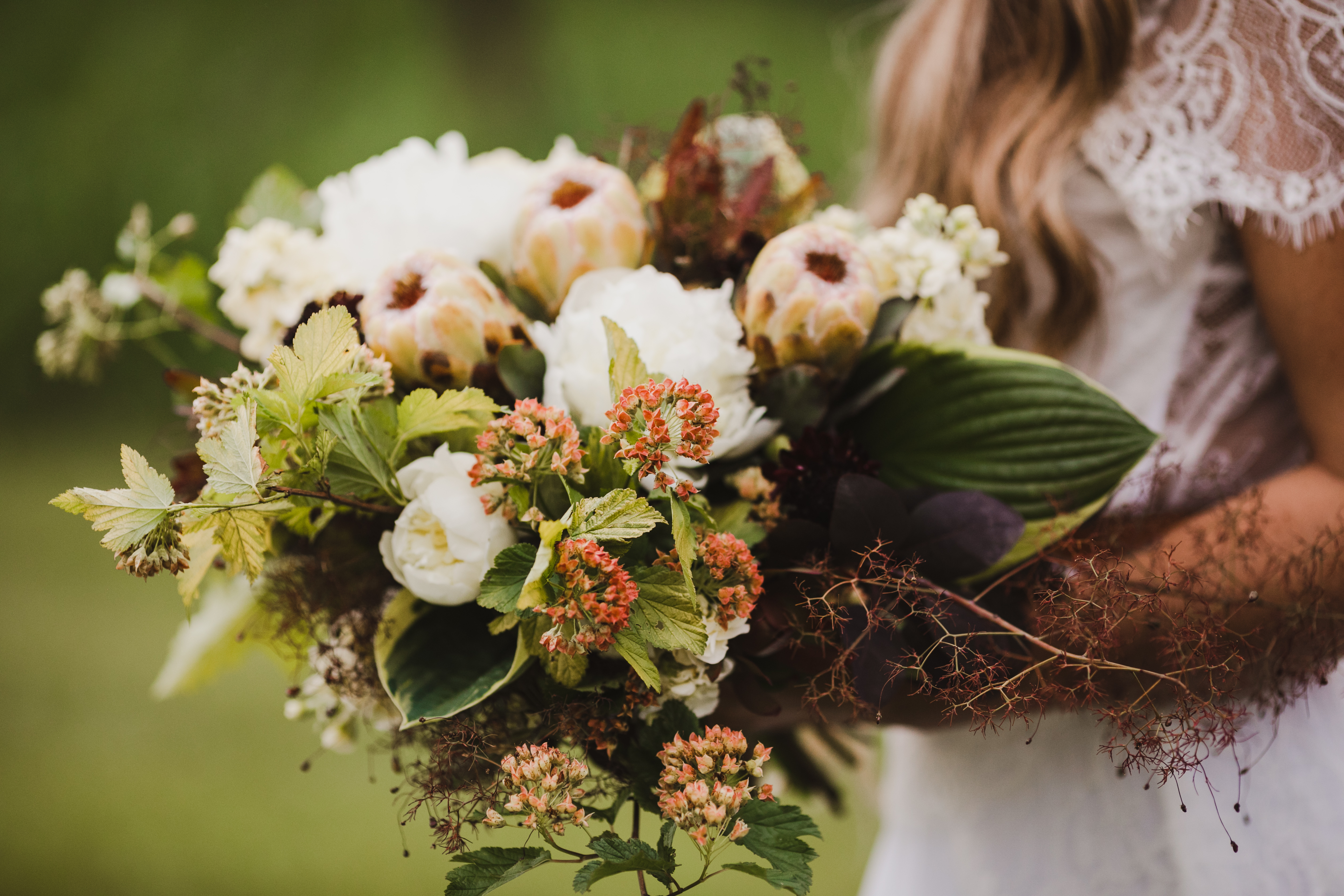 Person holding a bridal bouquet.