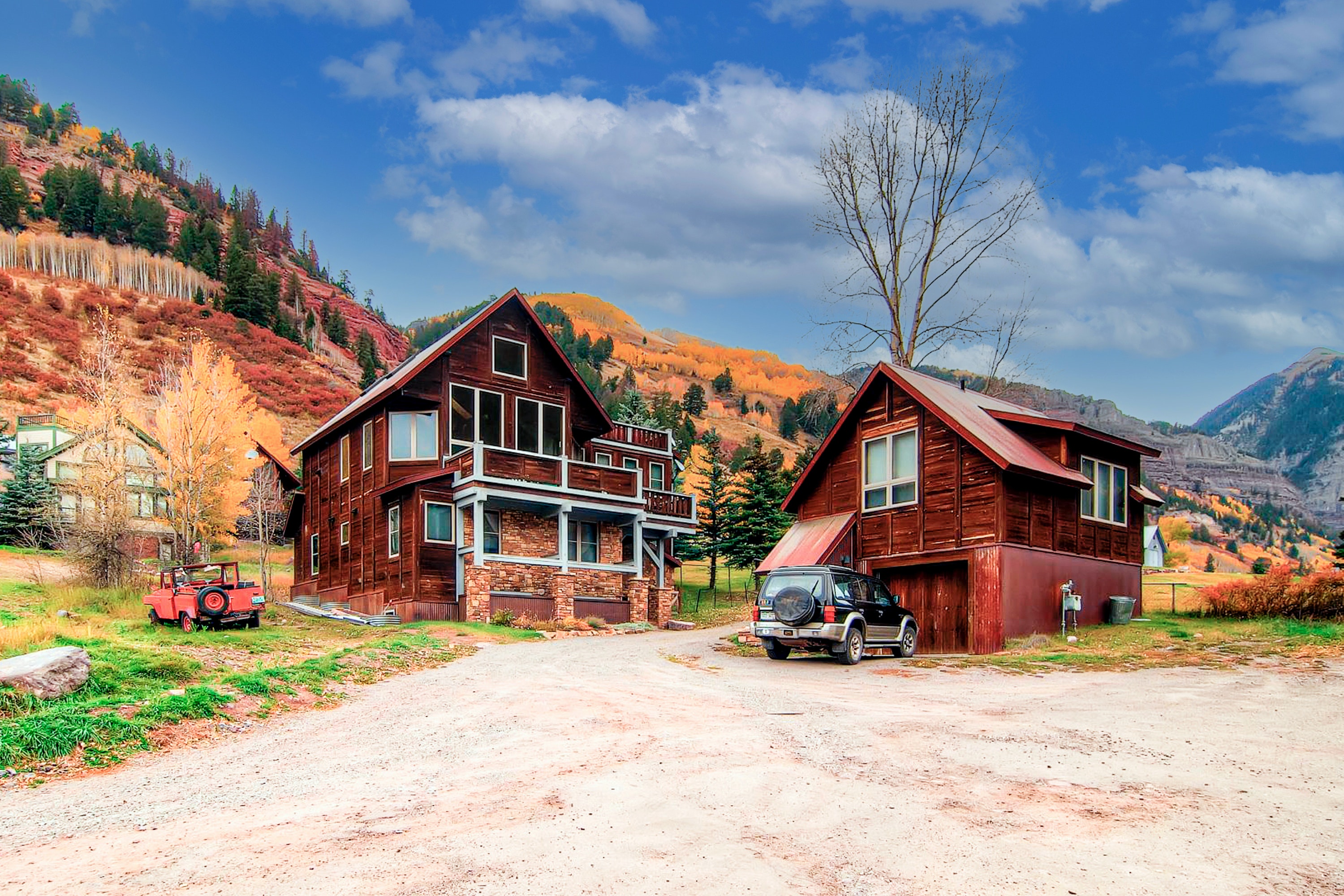vacation home with detached garage surrounded by fall foliage in telluride