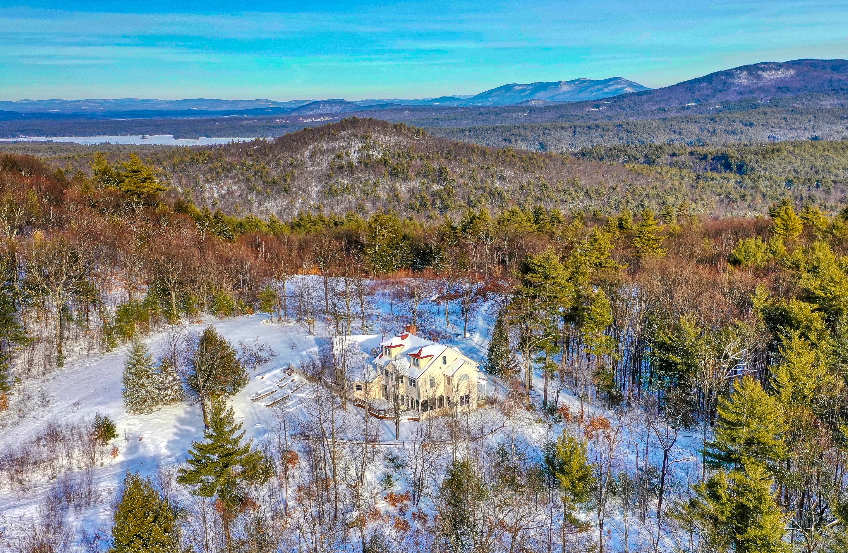 remote vacation home surrounded by forest and a light early snow in NH