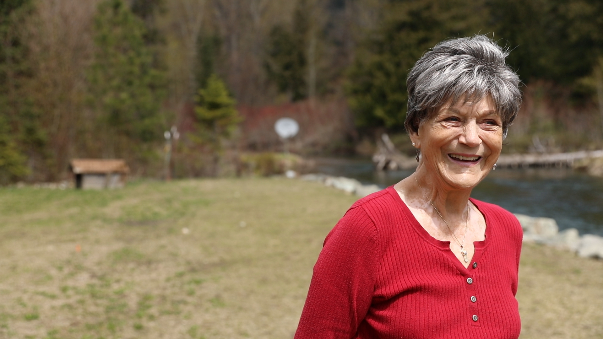 Vacasa homeowner Diane smiles outside of her vacation home