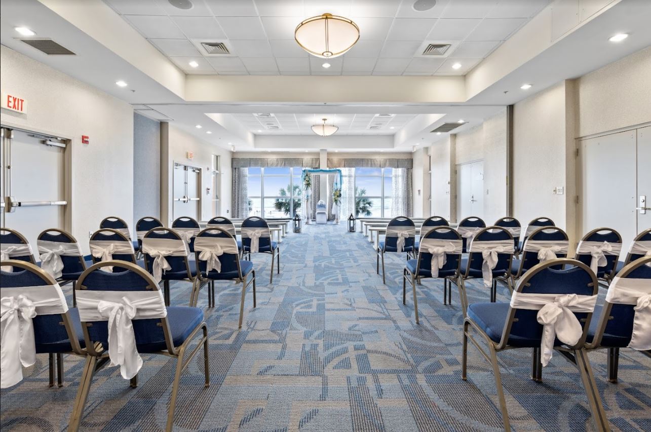 Chairs arranged in rows in a hallway for a wedding ceremony.