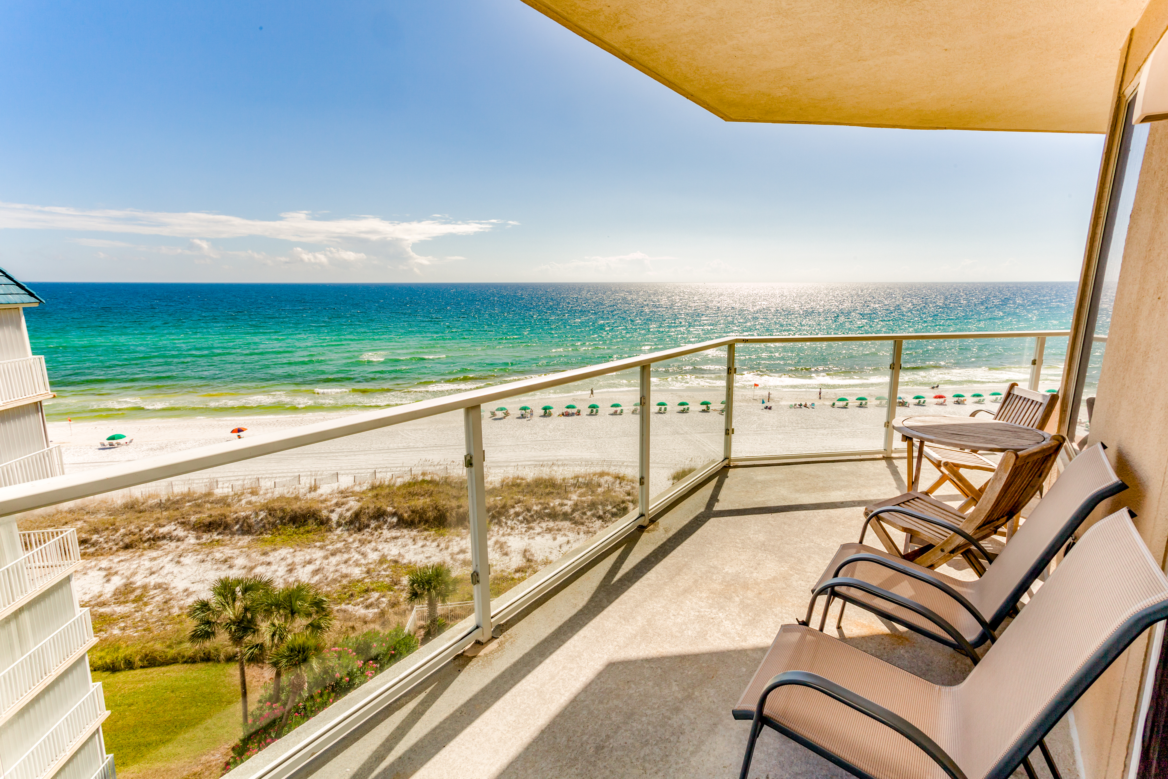A patio of a Destin, FL vacation rental overlooking the beach.