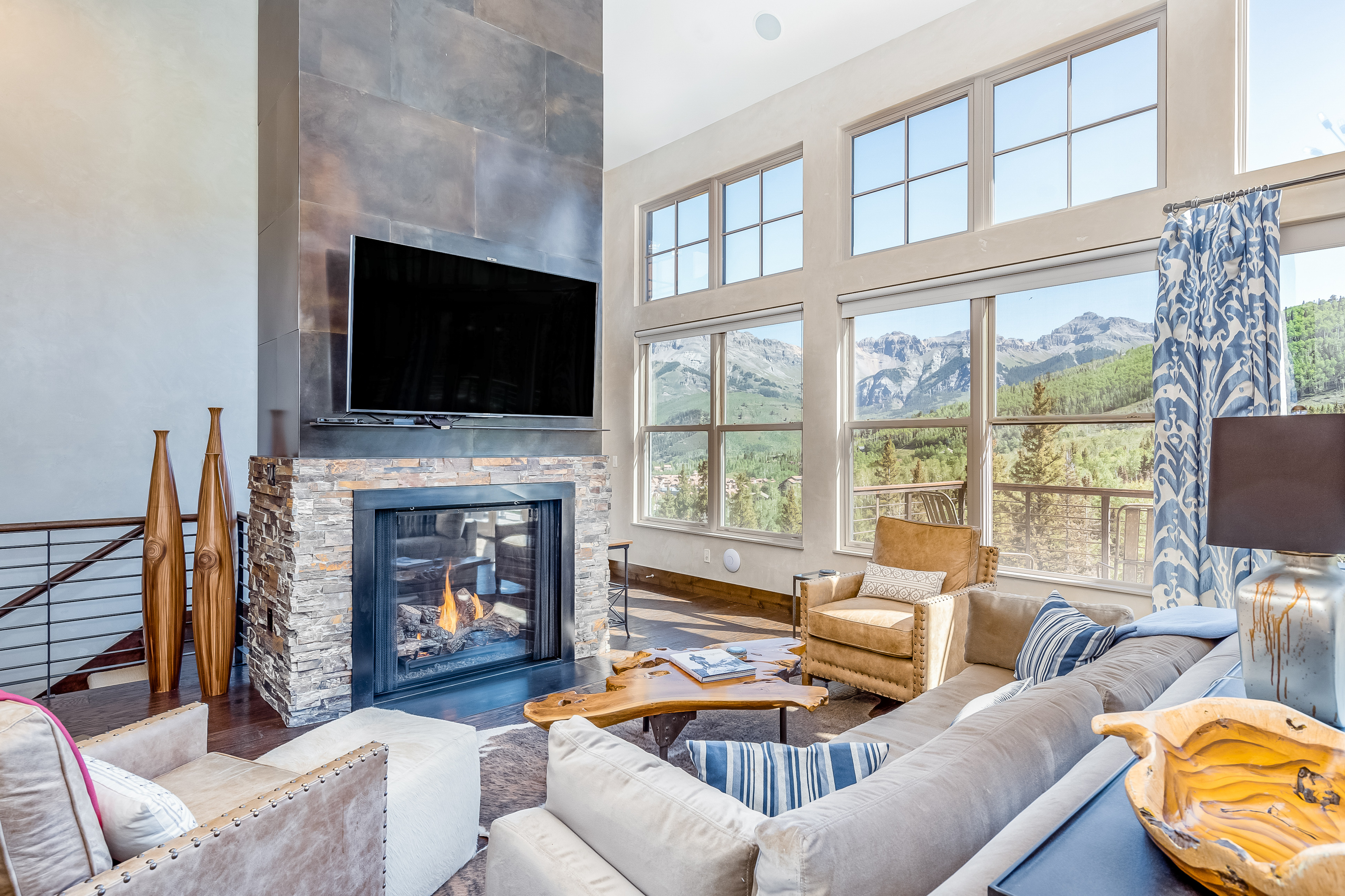 Living room with an indoor fire place and a mountain view from a vacation home