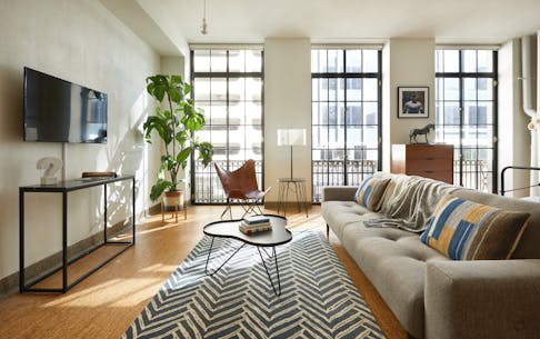 the living room of a downtown vacation condo with modern furniture