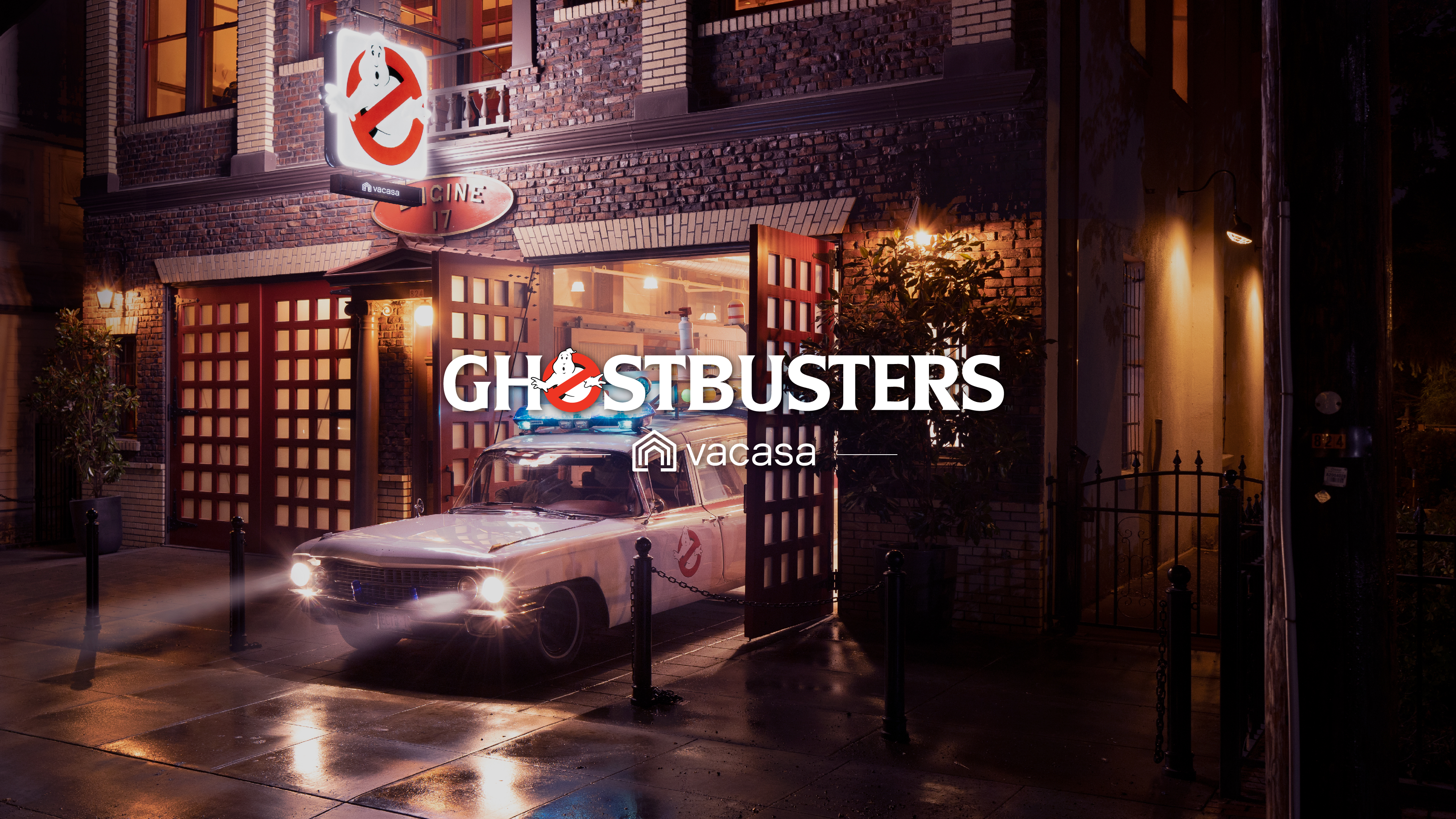 Ghostbusters + Vacasa logos, with a Portland Firehouse in the background
