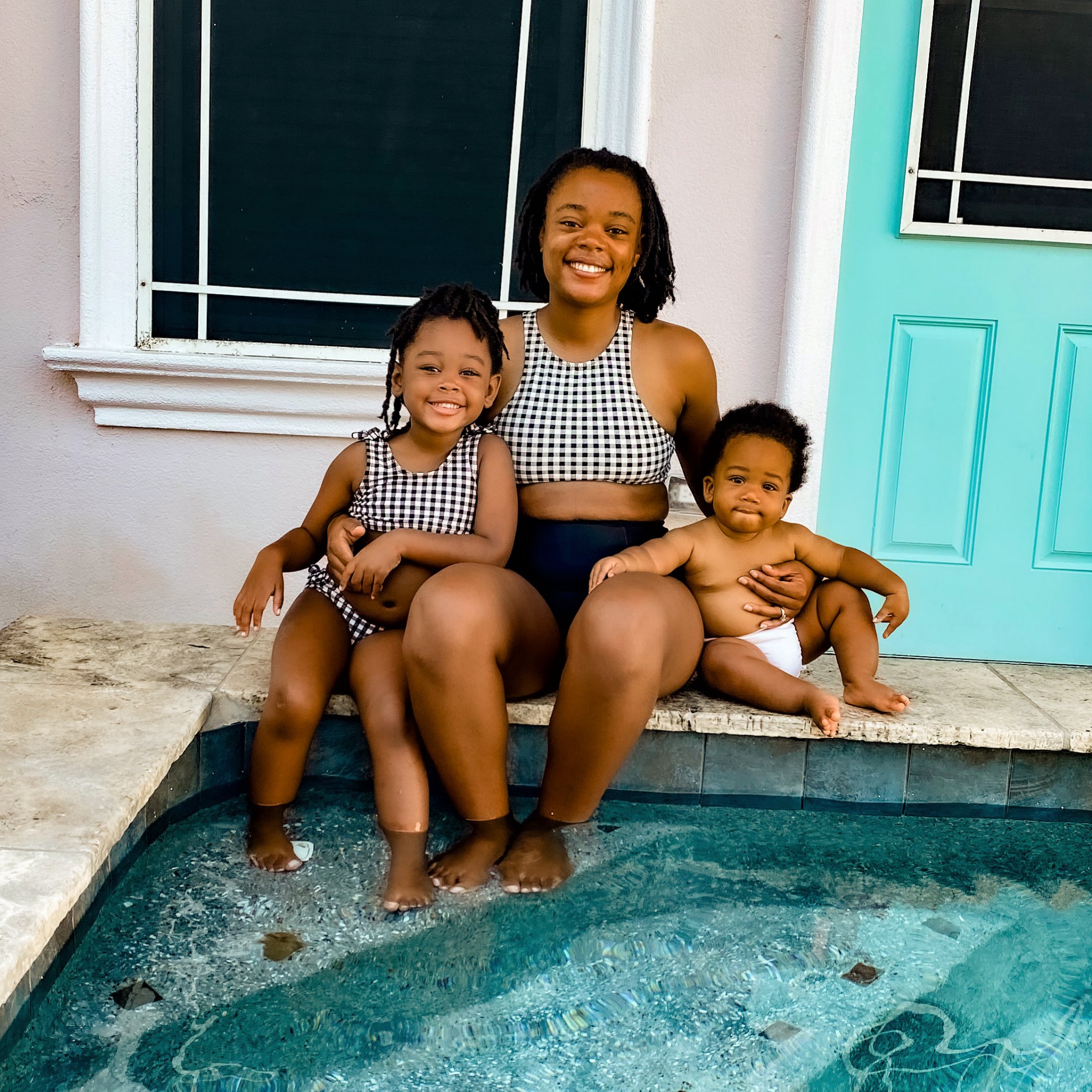 Victoria Graham and her two children dip their toes in the private pool of their vacation rental