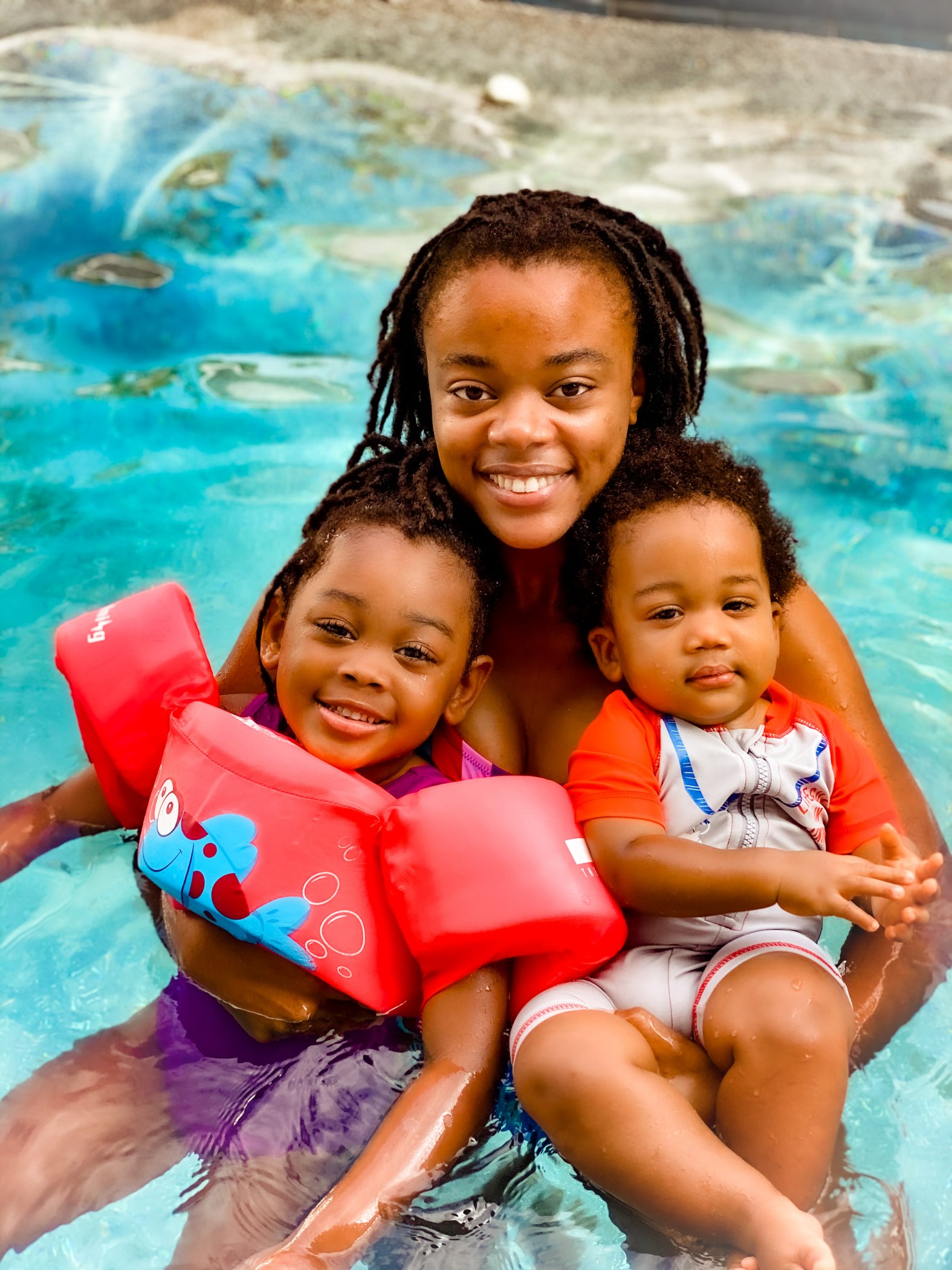 Victoria Graham and her two children swim in the private pool of their vacation rental