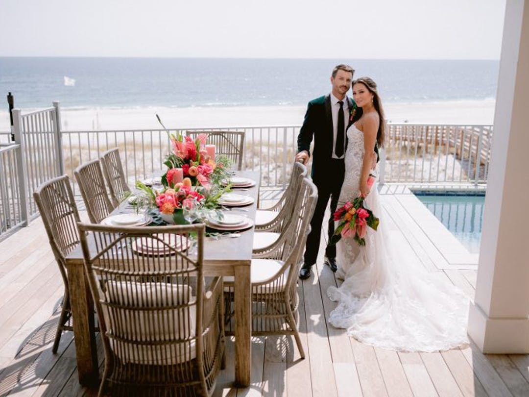 bride and groom pose for wedding pictures at their Alabama Gulf Coast wedding-friendly vacation rental