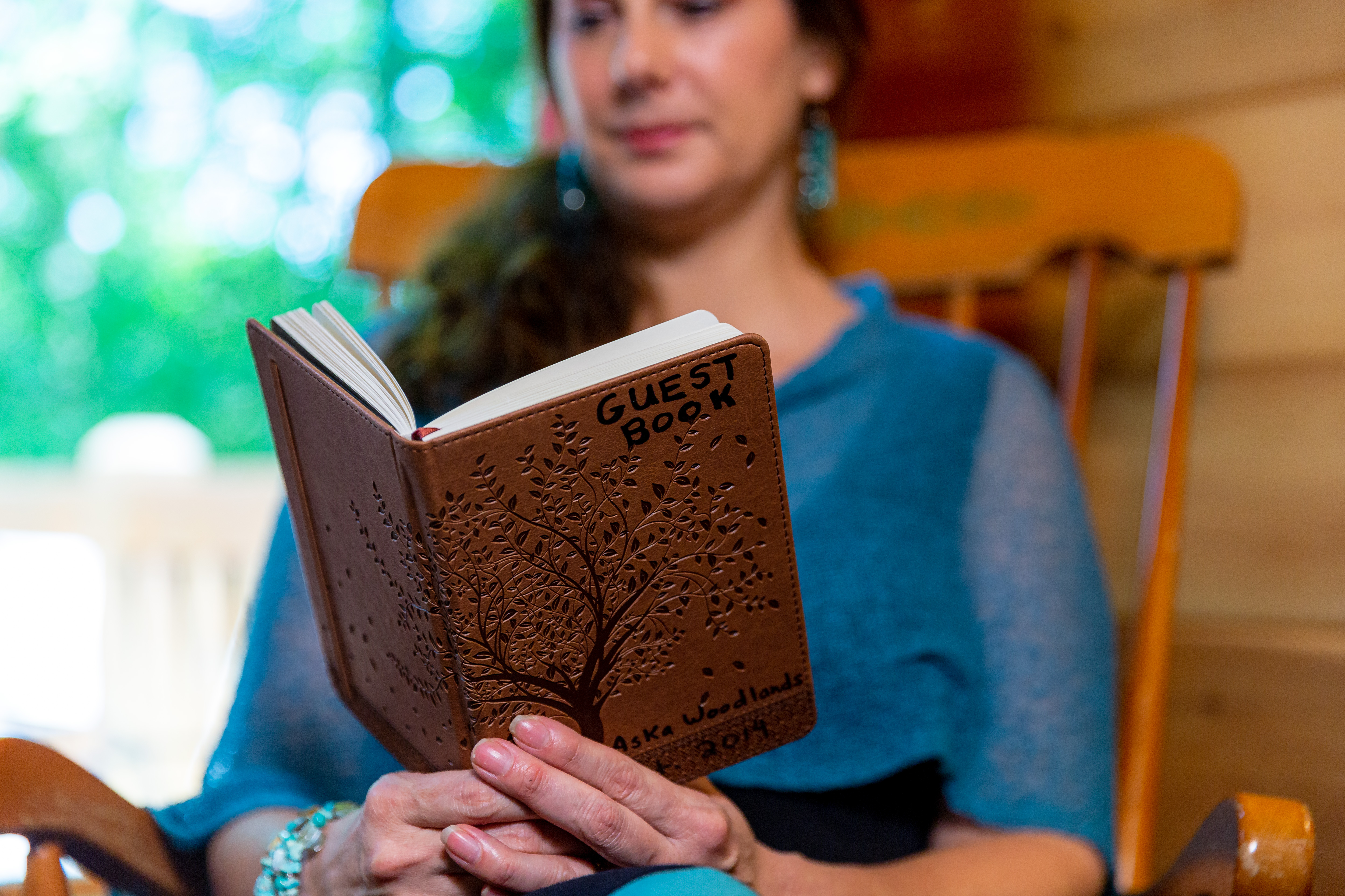 woman reads through vacation rental guest book
